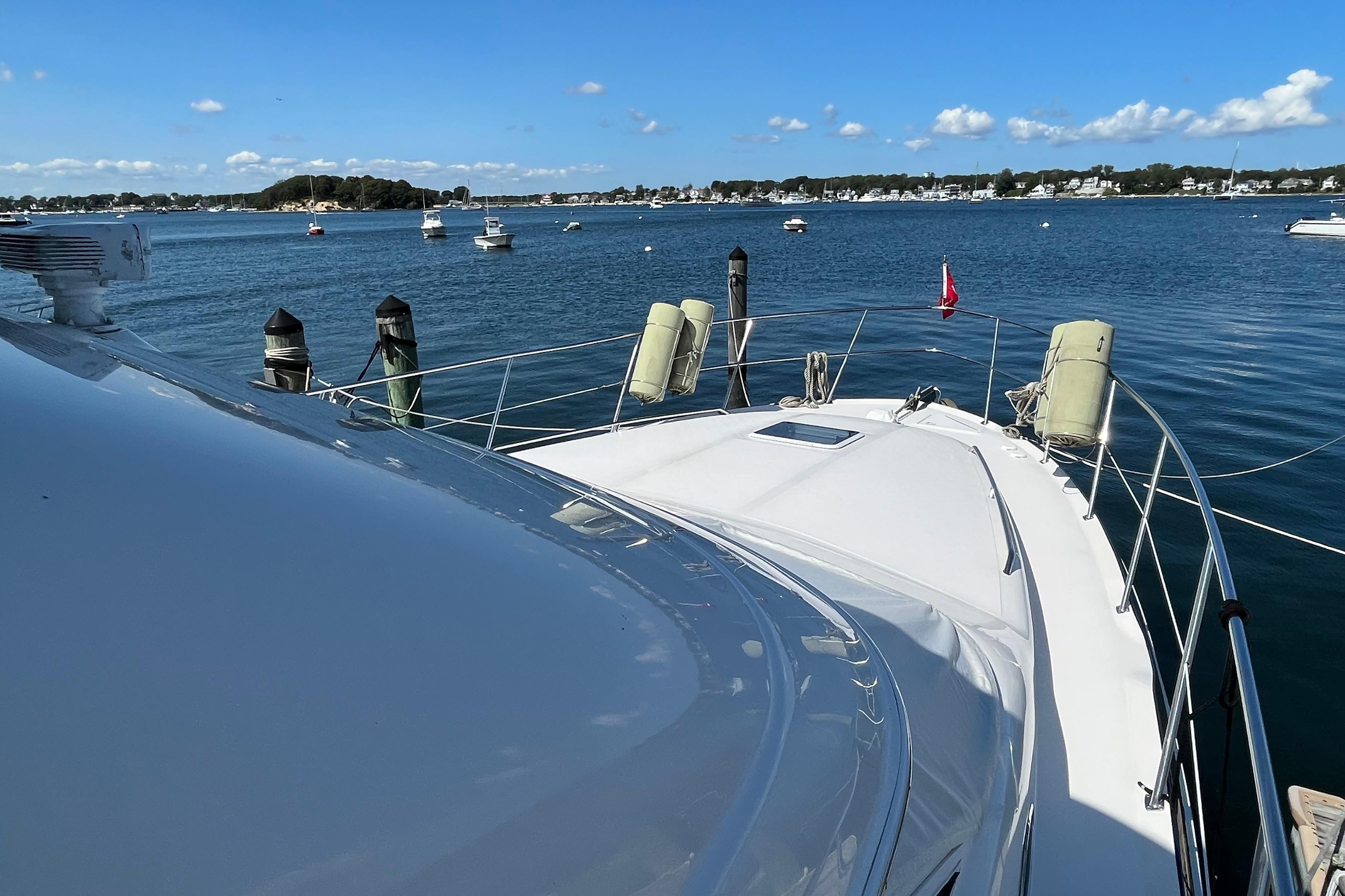 1997 Sea Ray 420 Aft Cabin yacht docked in a scenic harbor.