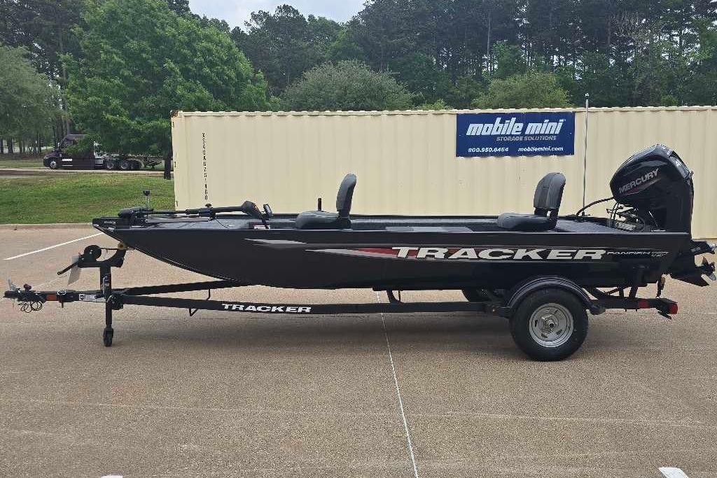 2026 Tracker Panfish 17 boat on trailer, parked outdoors near storage container.