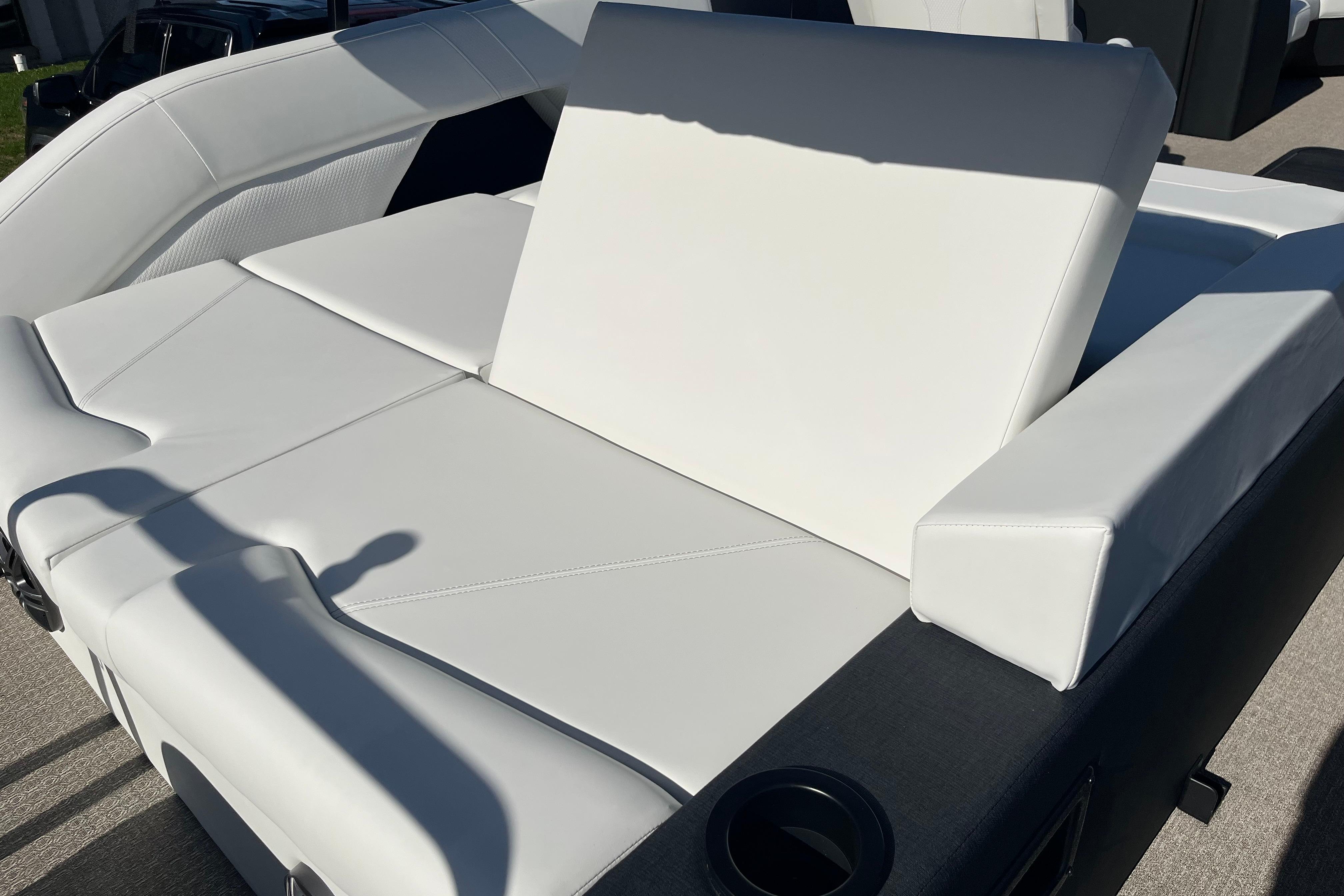 Luxurious white seating on 2026 Evotti 523CS boat, featuring cup holders and modern design.