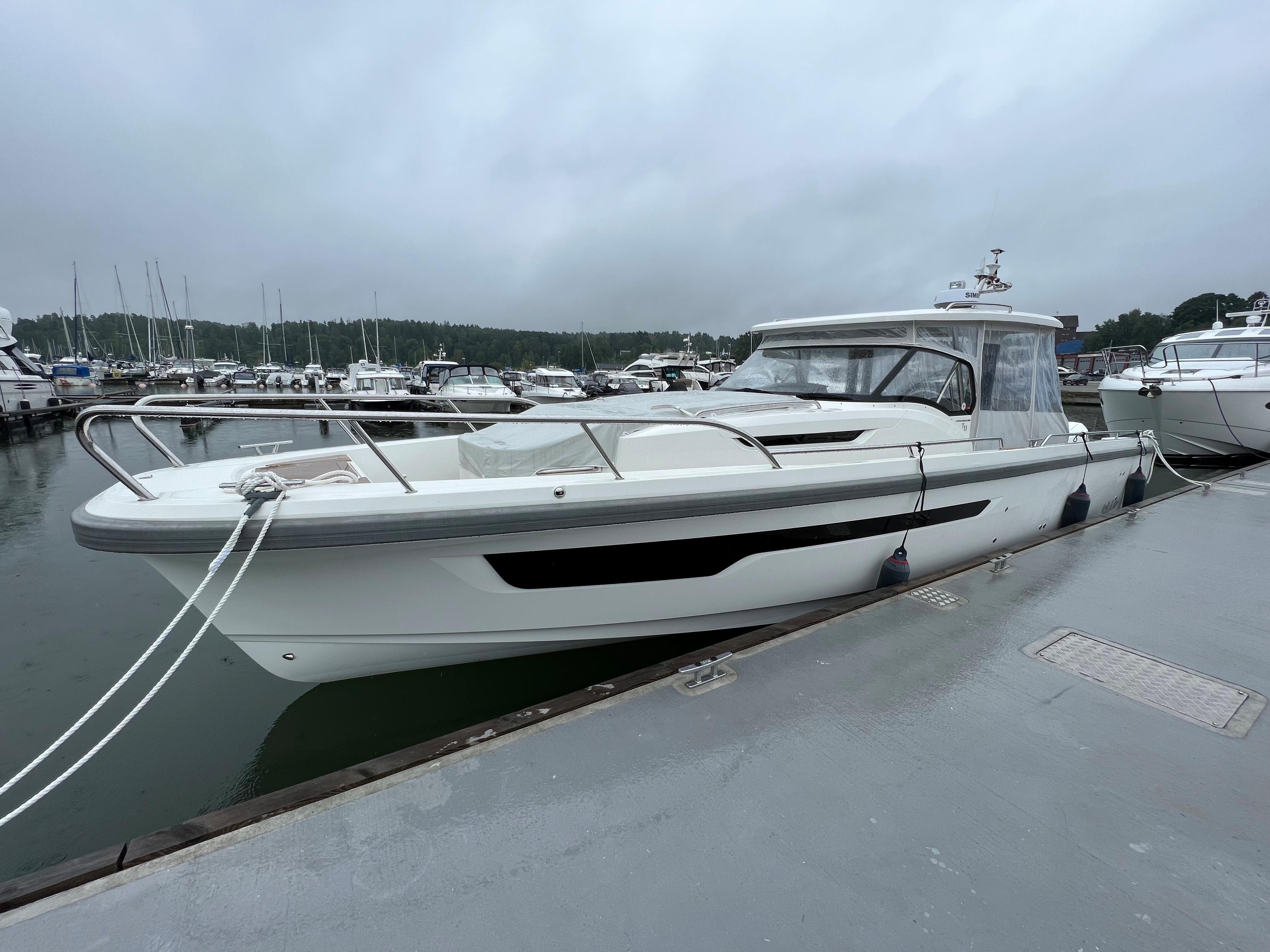Nimbus Tender 11, 2021 model, docked at a marina on a cloudy day.