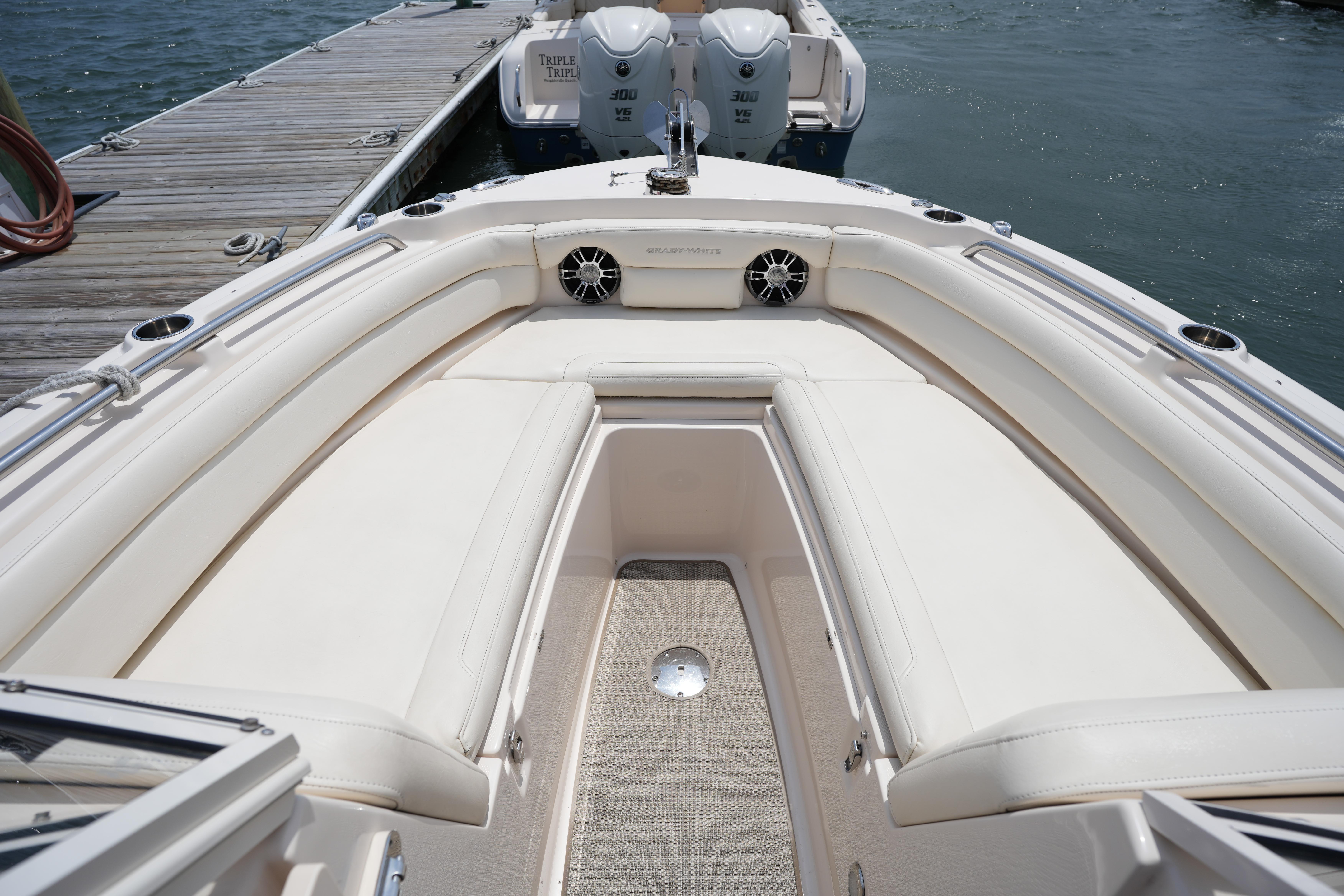 2021 Grady-White Freedom 235 boat interior with cushioned seating and docked at marina.