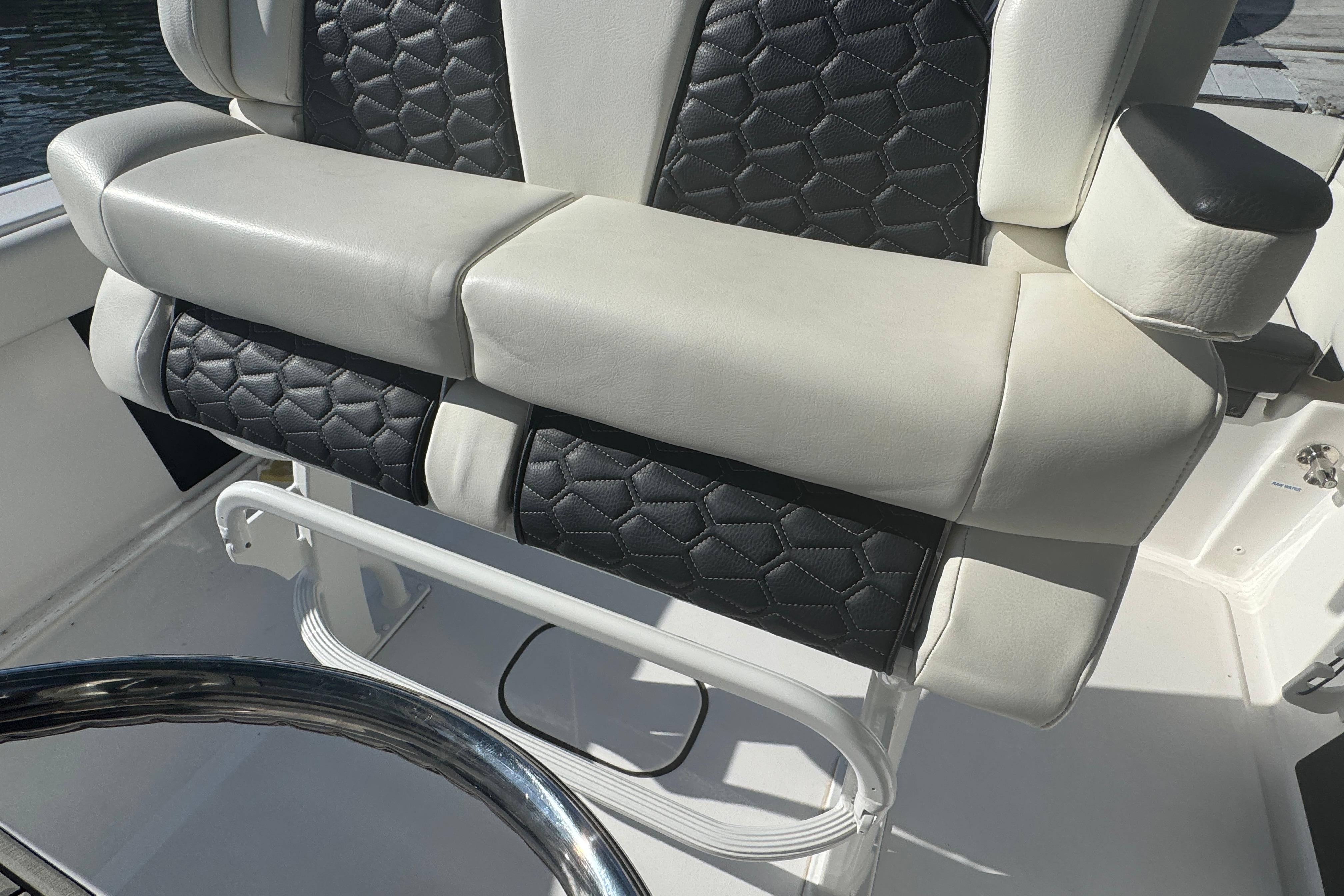 Luxurious seating on 2025 Tidewater 232 LXF boat, featuring stylish black and white upholstery.