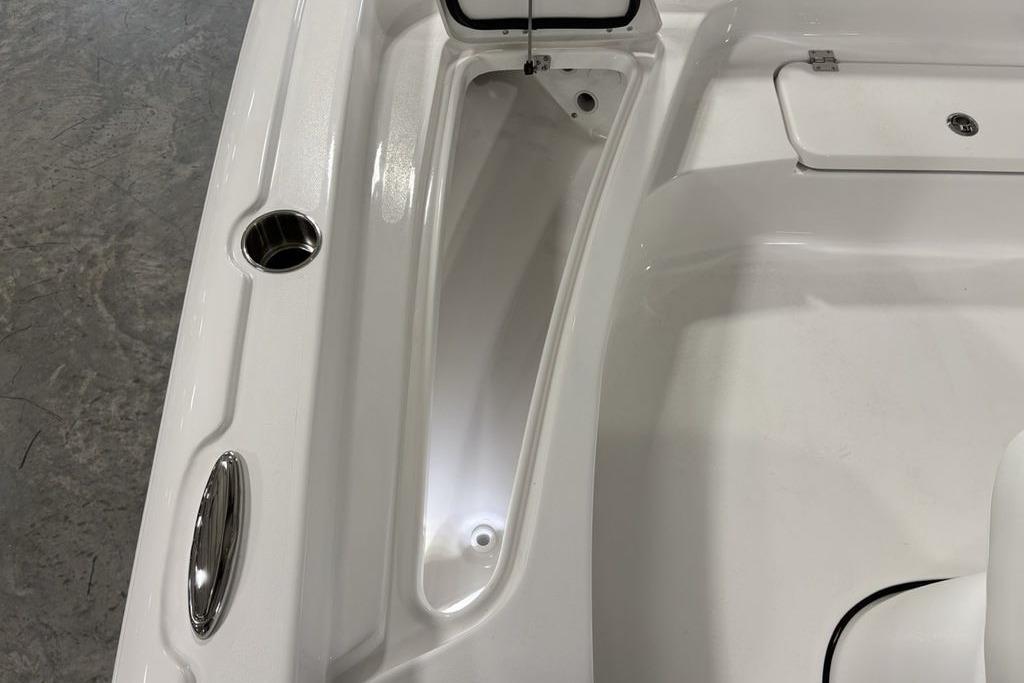 2026 Tidewater 2210 Carolina Bay boat interior with storage compartment and cup holder.