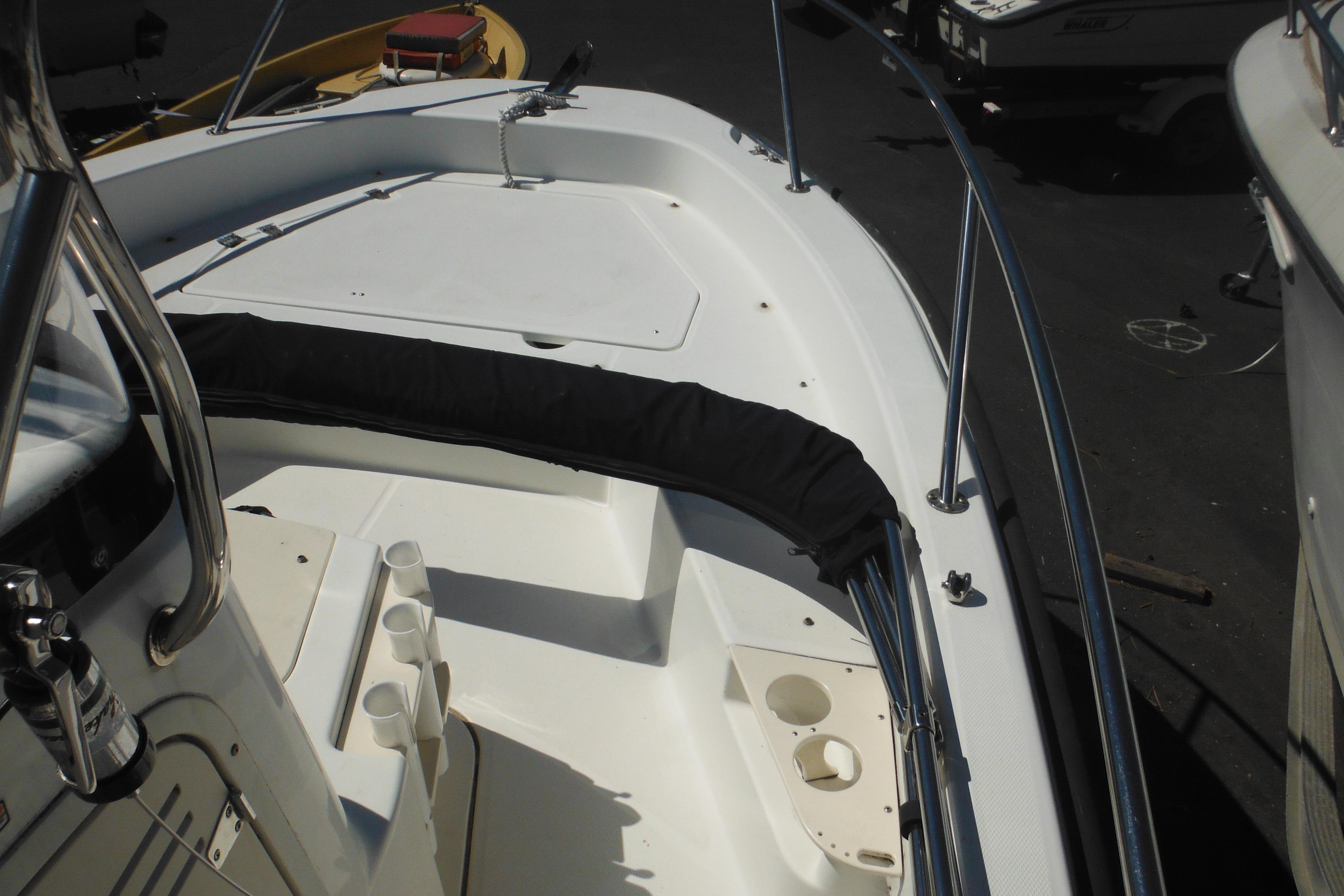 2009 Boston Whaler 200 Dauntless boat deck with seating and stainless steel railings.