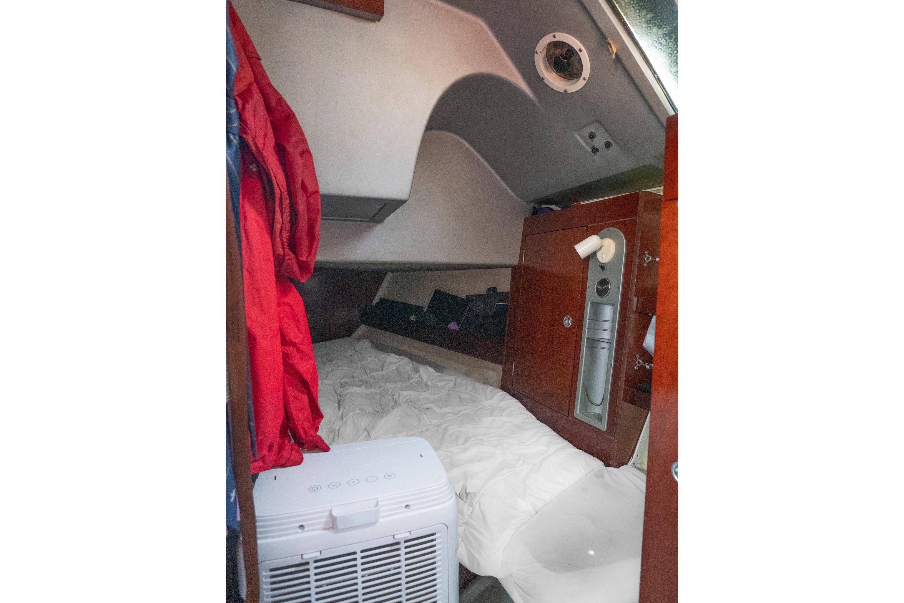 Cozy cabin interior of 1993 Beneteau First 38 s5 sailboat with bedding and storage.