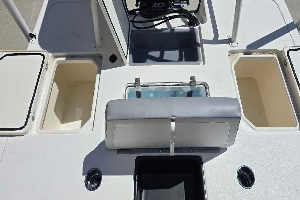 2026 Mako 18 Pro Skiff boat interior with storage compartments and seating.