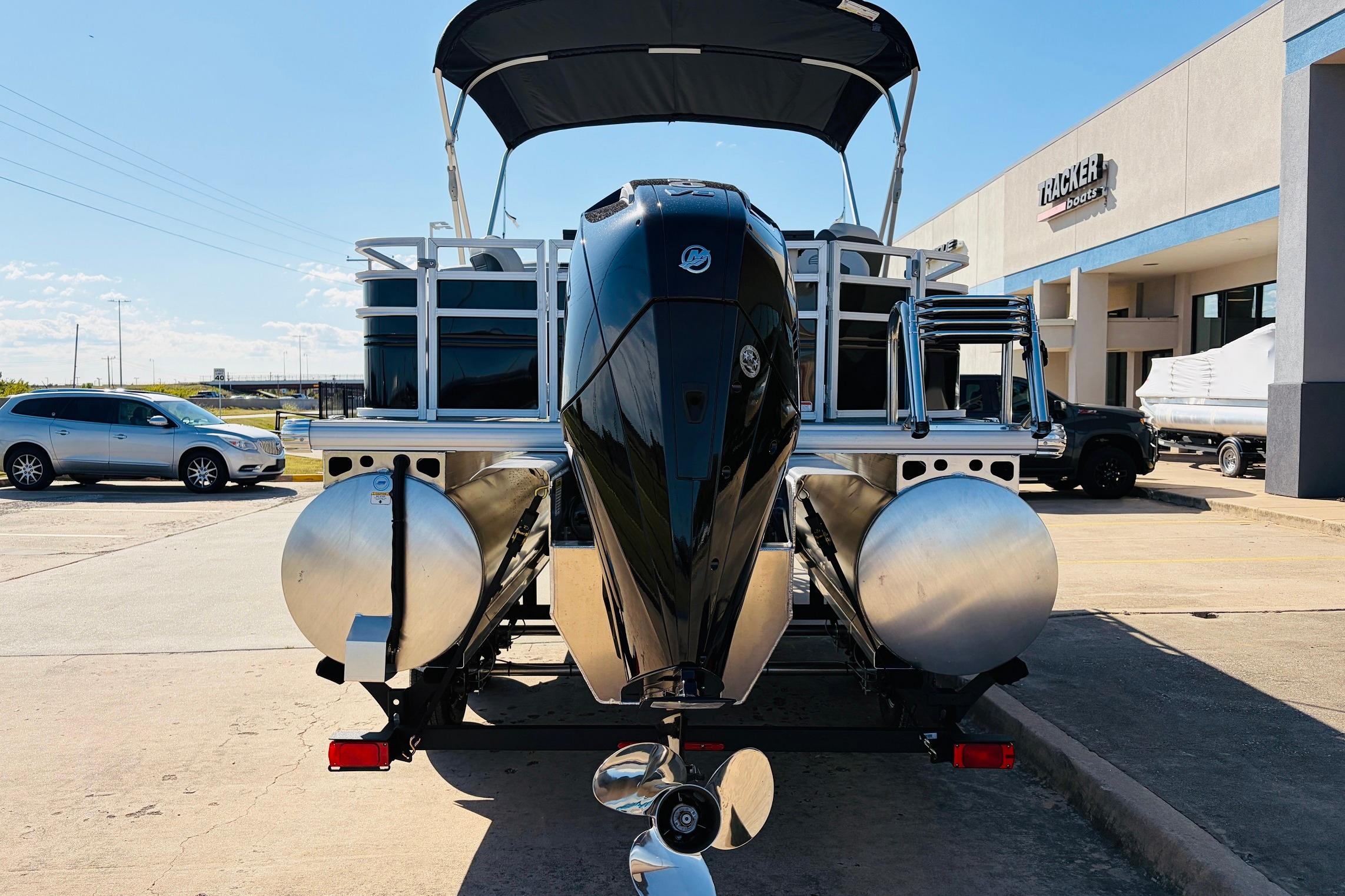 2026 Sun Tracker Fishin' Barge 22 XP3 pontoon boat at dealership, rear view.