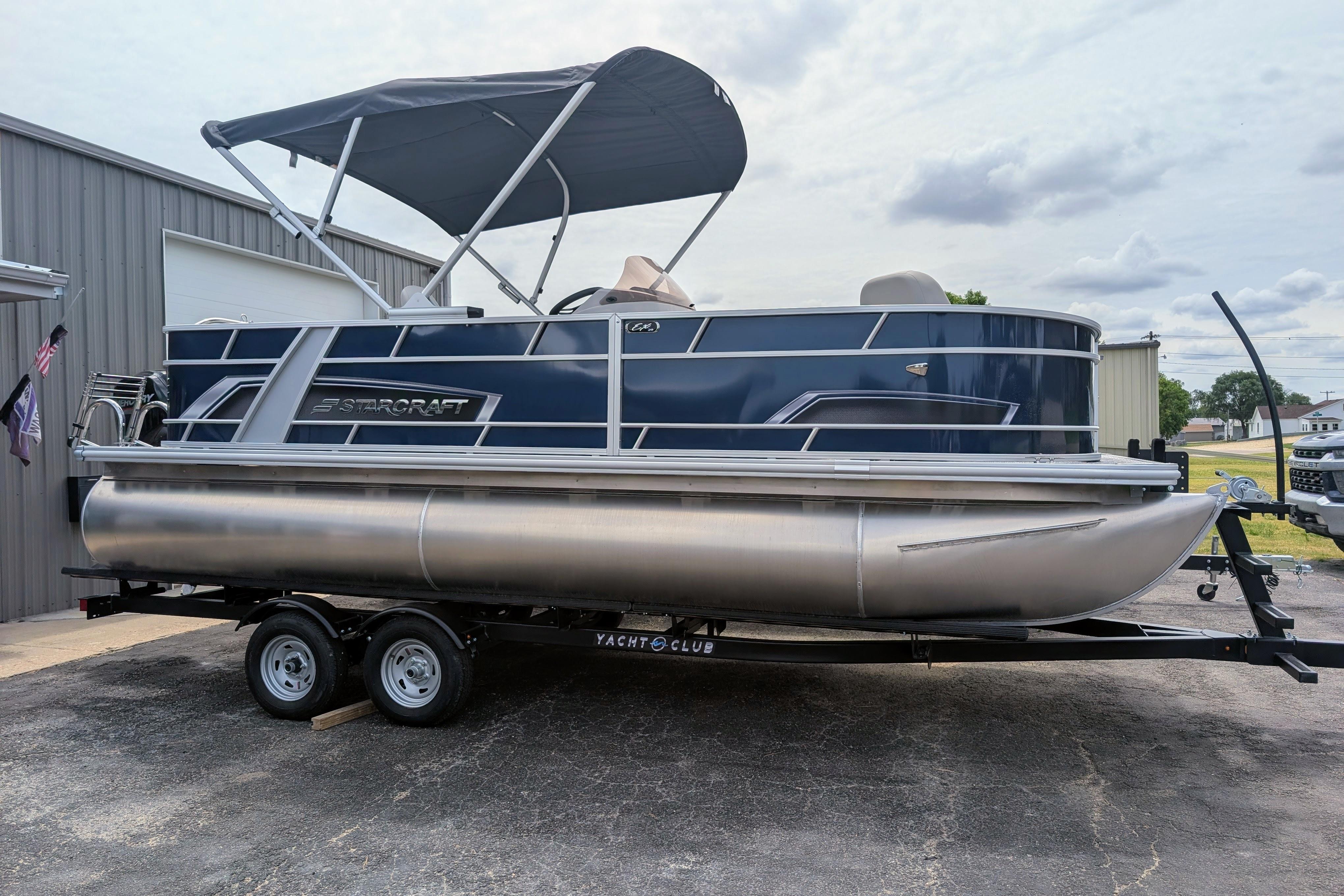 2026 Starcraft EX 20 F pontoon boat on trailer, parked outdoors.