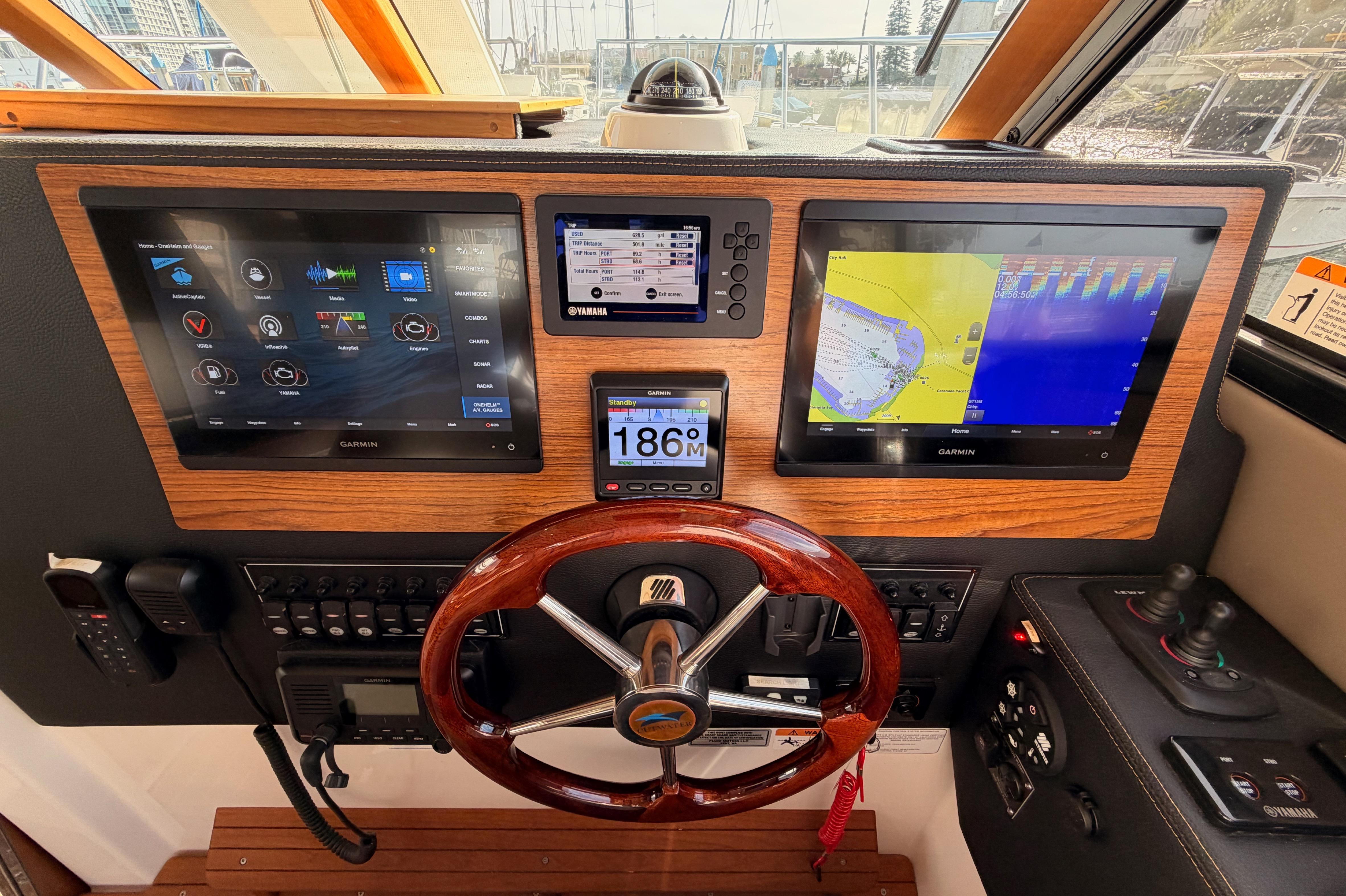 Helm of 2021 Cutwater C-32 CB with advanced Garmin navigation displays and controls.