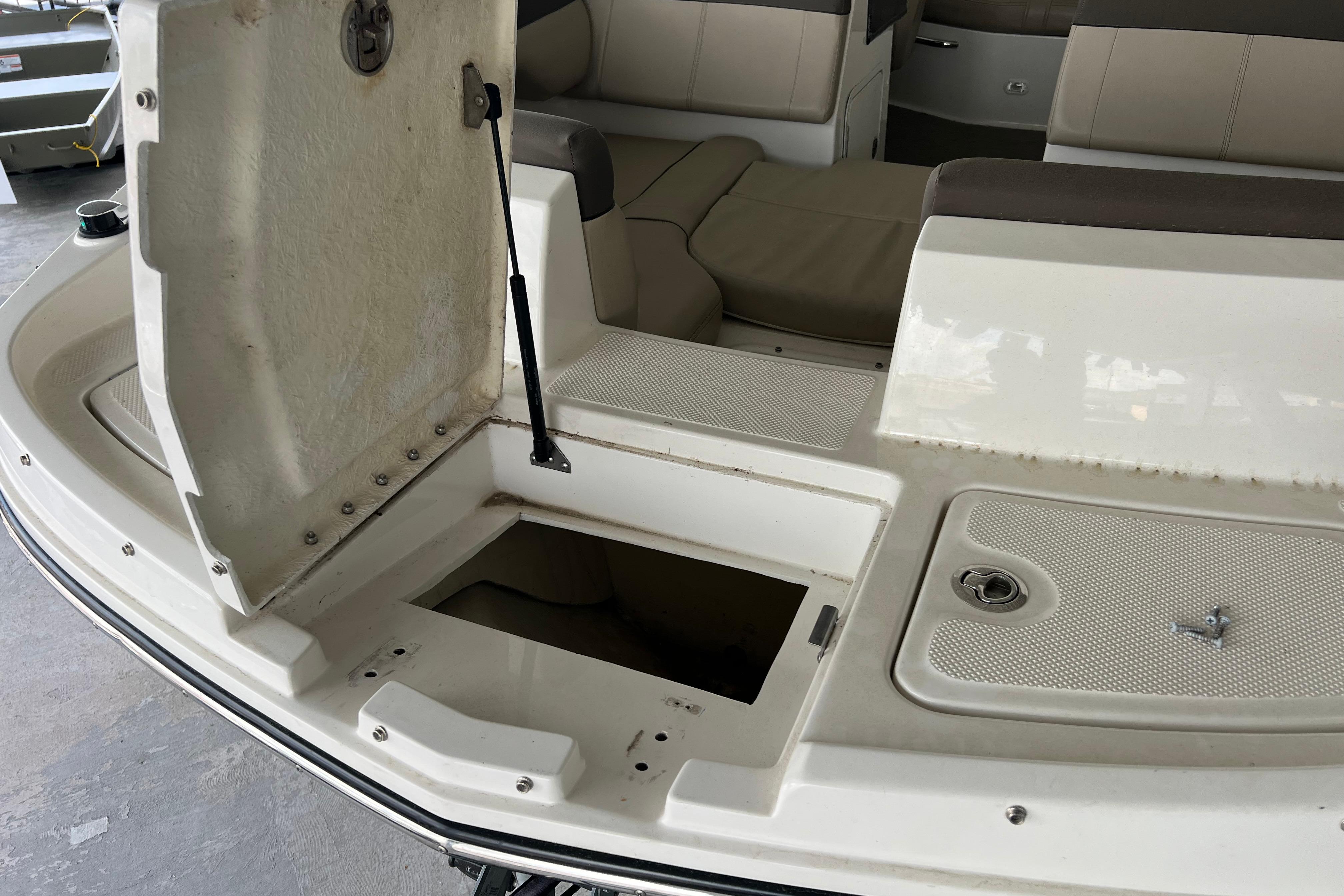 2017 Bayliner 195 Deck Boat interior with open storage compartment and seating area.