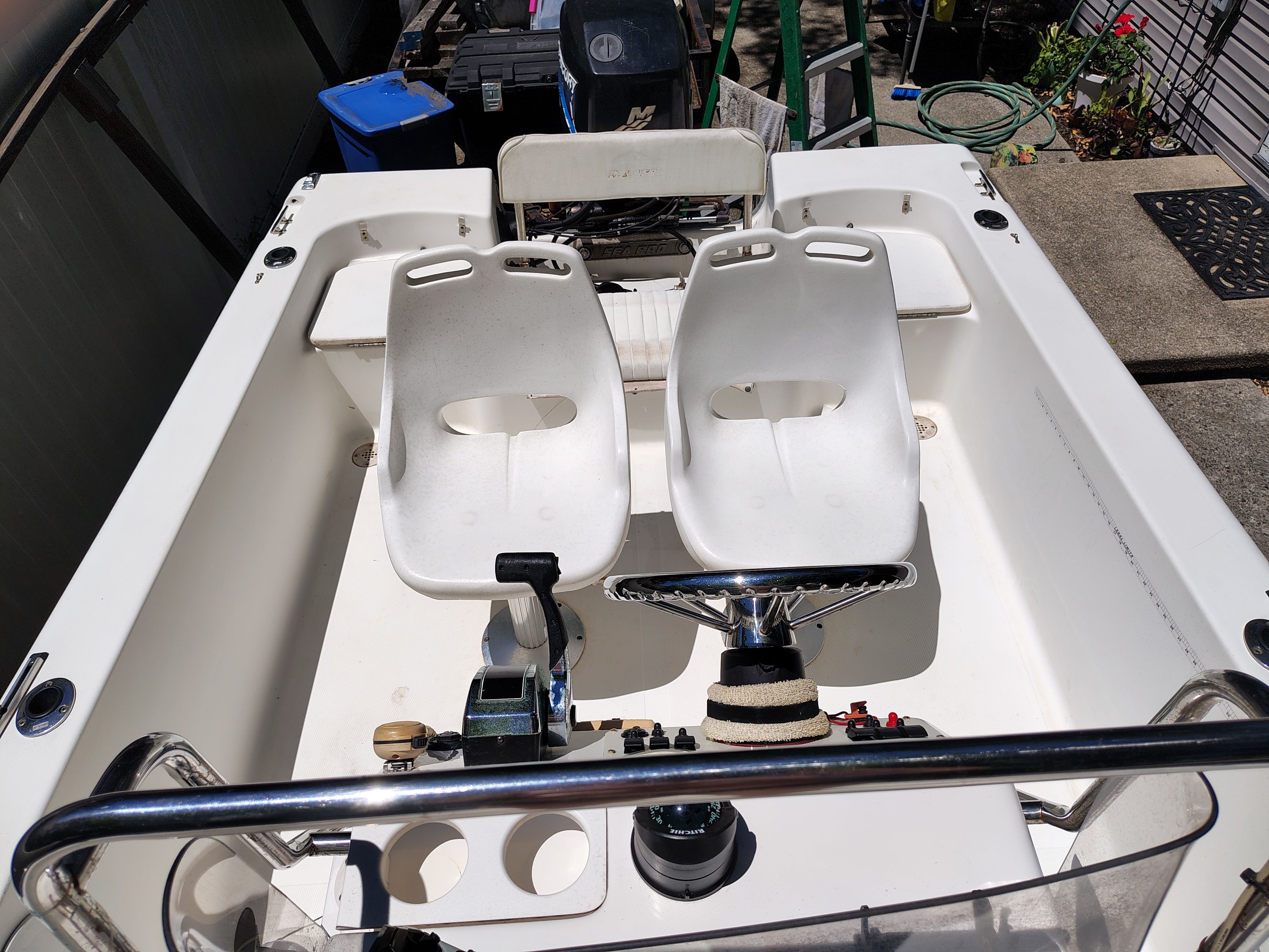 2003 Sea Pro 180 Center Console with two white seats and steering controls.