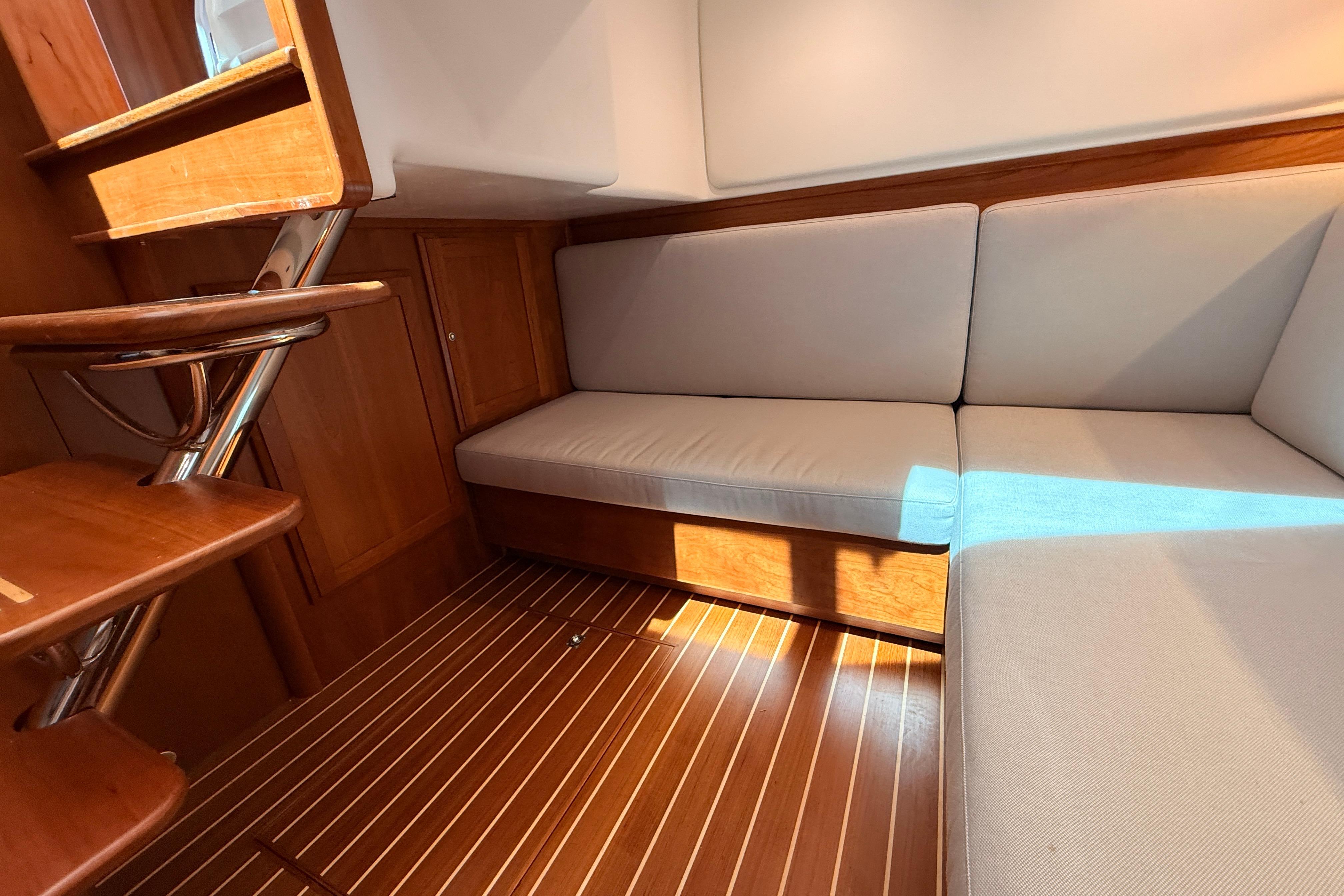 Interior of 2022 Sabre 38 Salon Express with wooden flooring and cushioned seating.