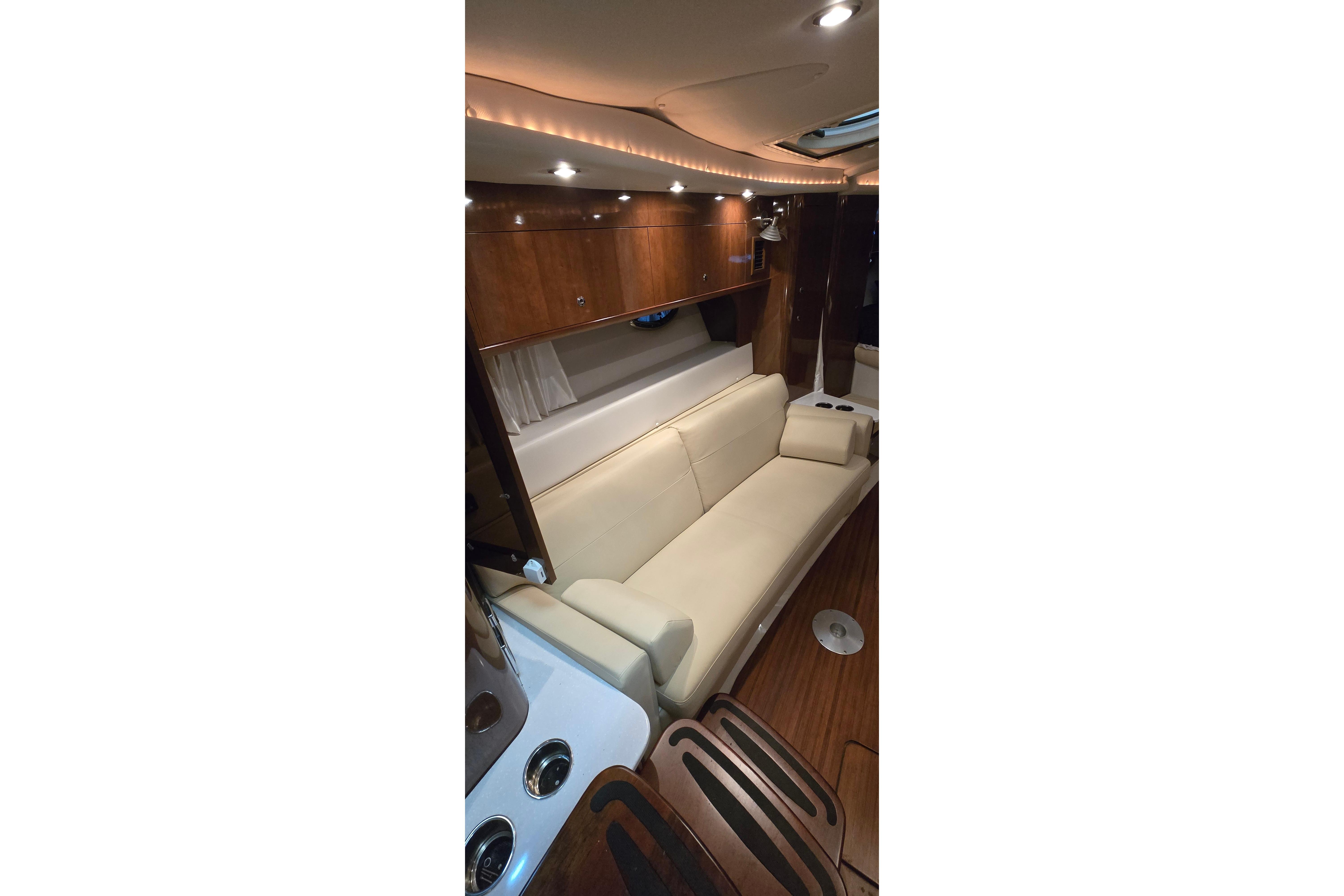 Luxurious interior of 2018 Four Winns V355 yacht with elegant seating and wood finishes.