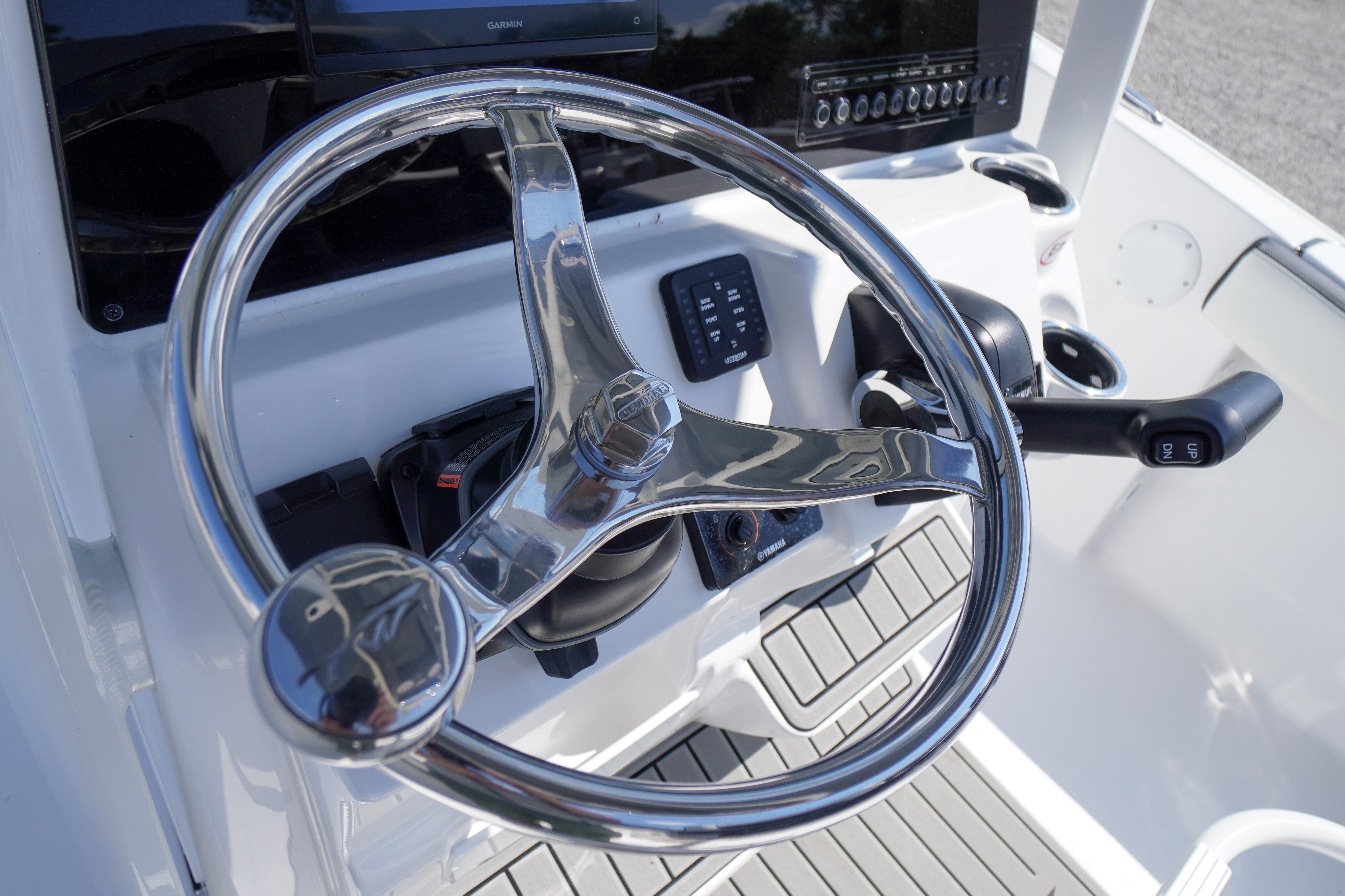 Steering wheel of 2026 Tidewater 220 CC Adventure boat, featuring modern controls and dashboard.