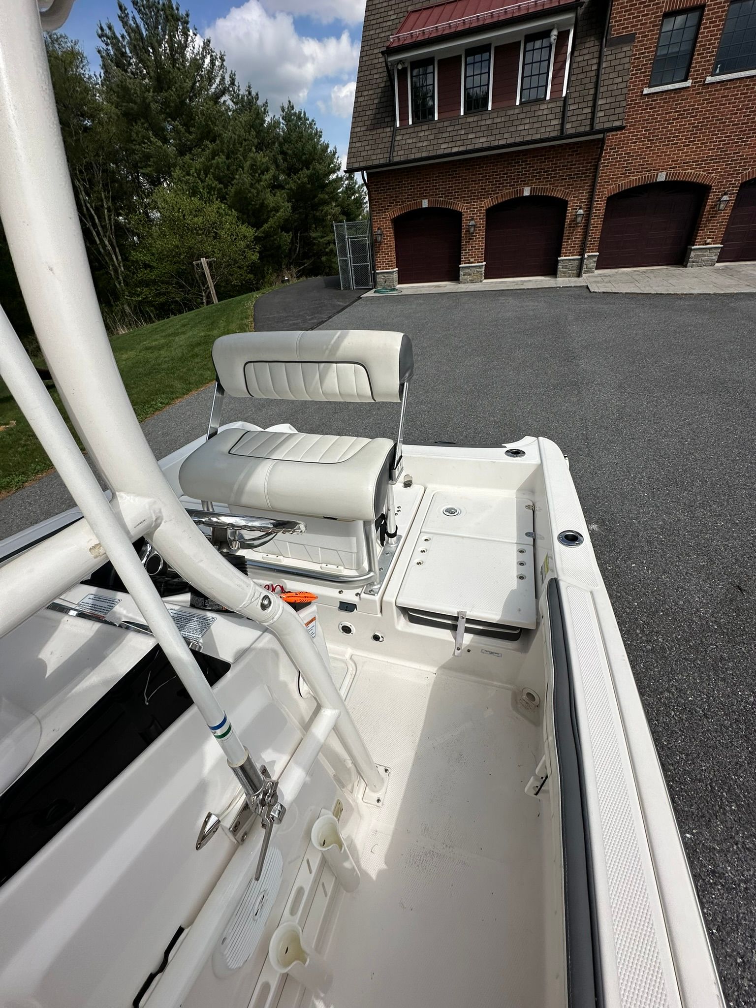 Yamaha 190 FSH Sport 2017 boat parked in front of brick garage.