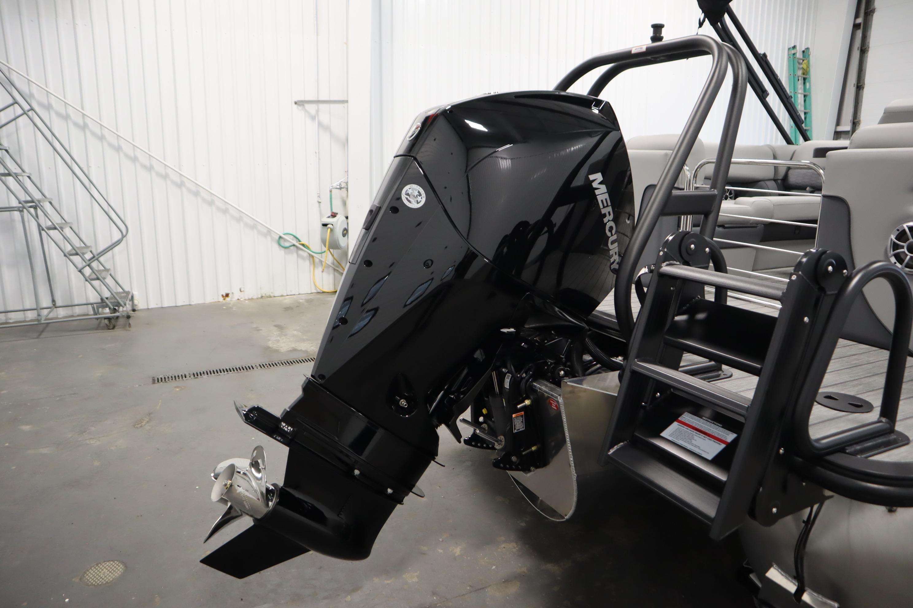 2025 Bentley Pontoons Elite 253 Admiral Tri-toon with Mercury outboard motor in a showroom.