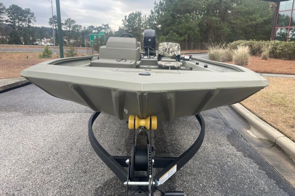 2026 Tracker Grizzly 1754 SC boat on trailer, parked outdoors, showcasing its sturdy design.