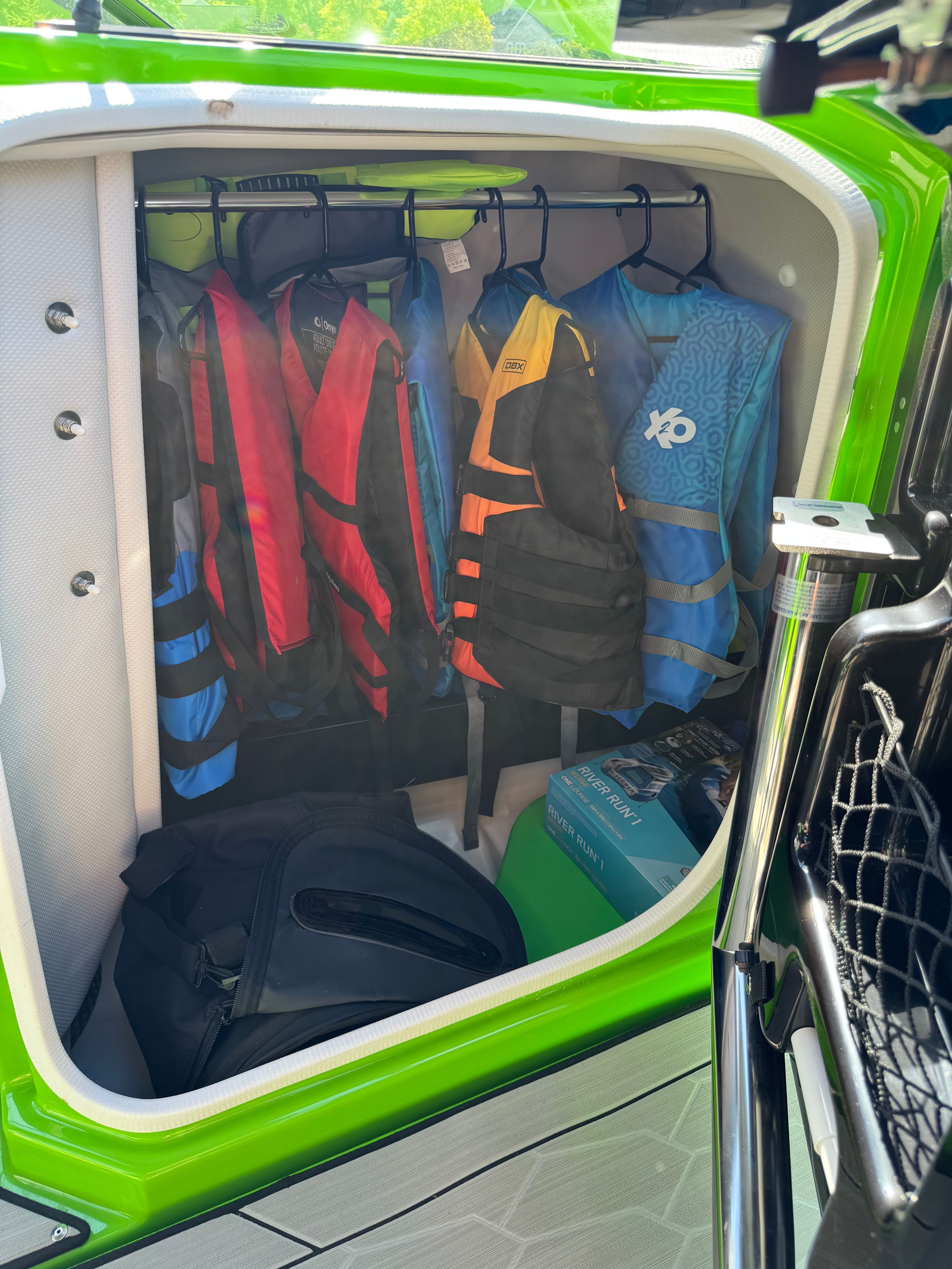 Storage compartment with life jackets on a Yamaha 255XD boat.