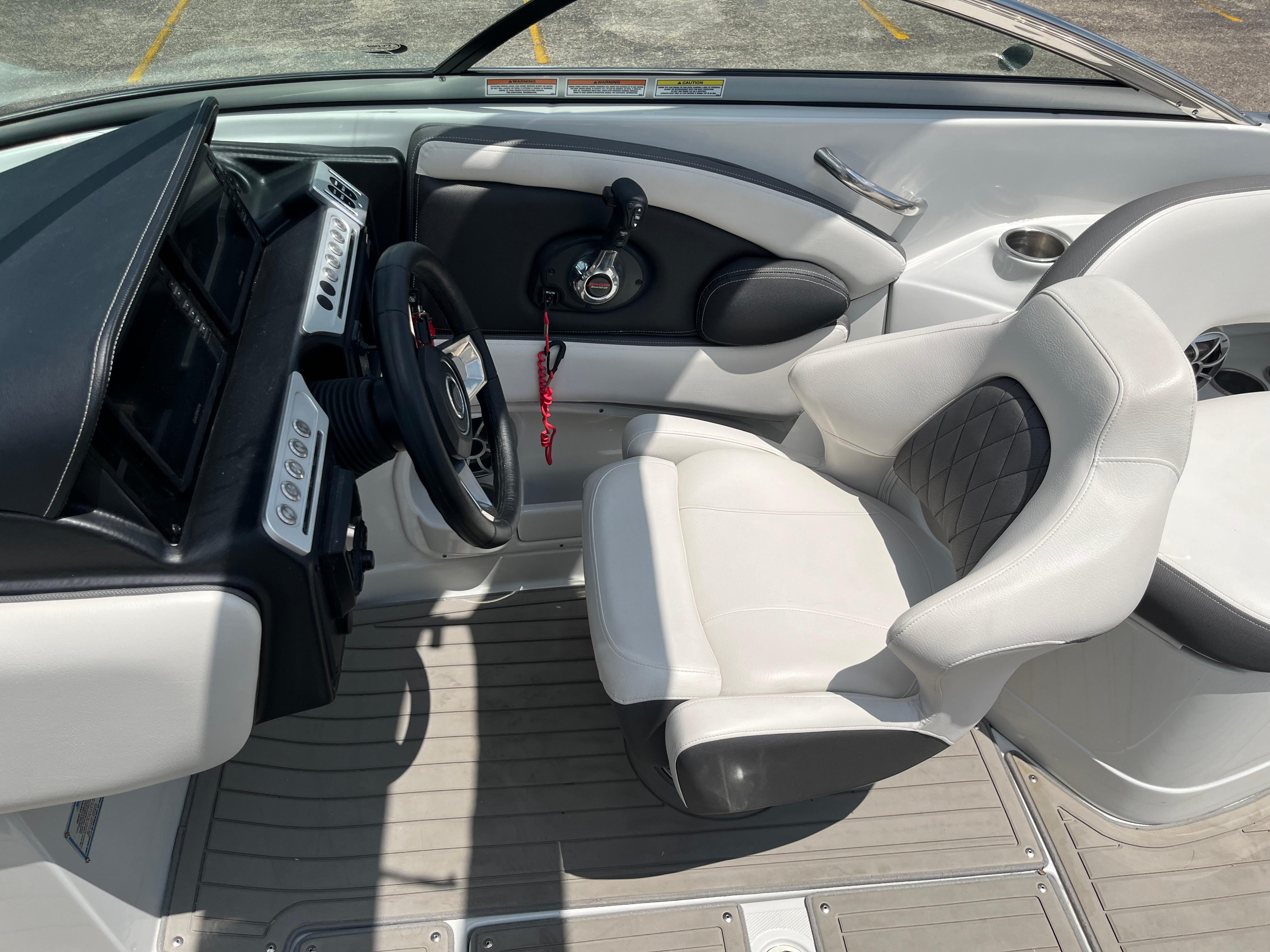 2022 Crownline 280 SS boat interior with steering wheel and captain's seat.