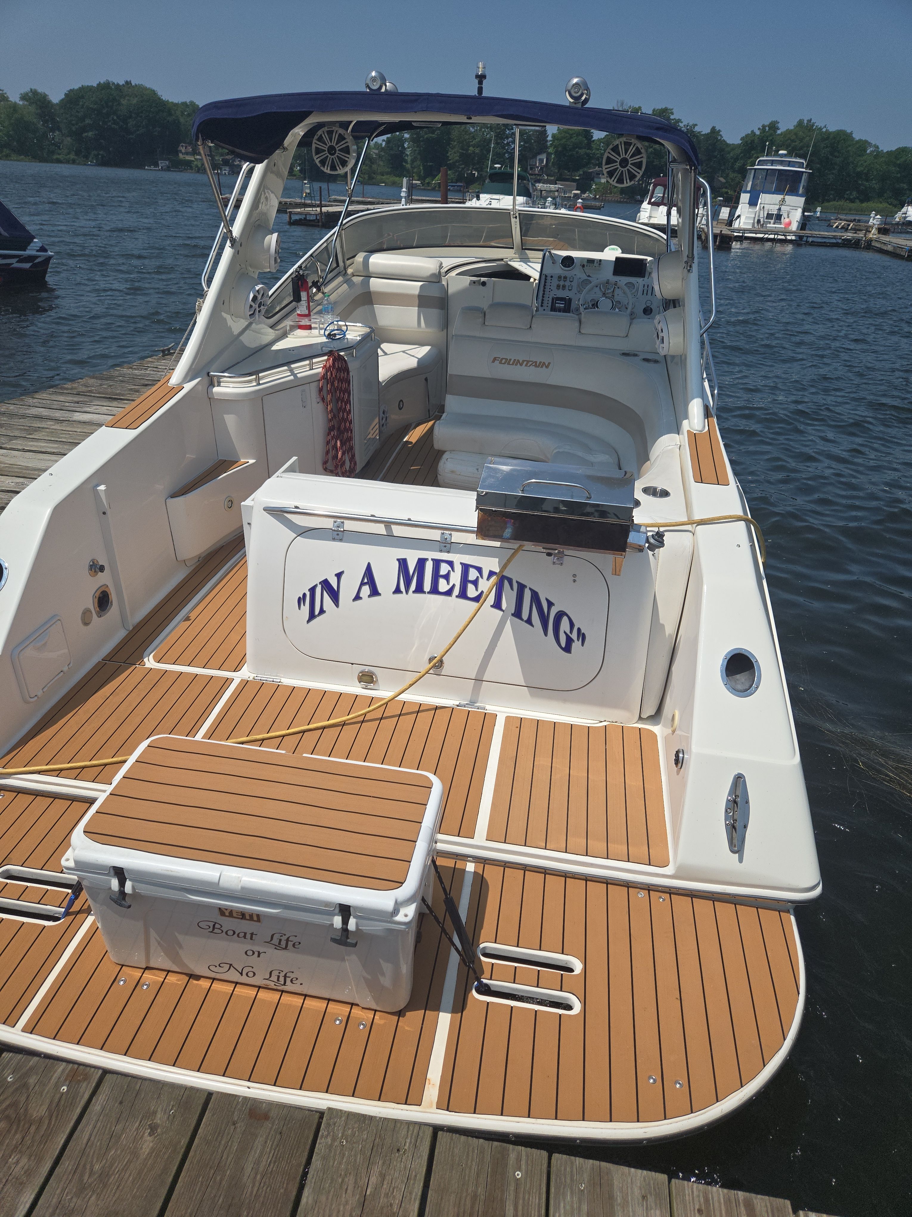 Fountain 38 Express Cruiser 2004 at dock, "In a Meeting" sign.