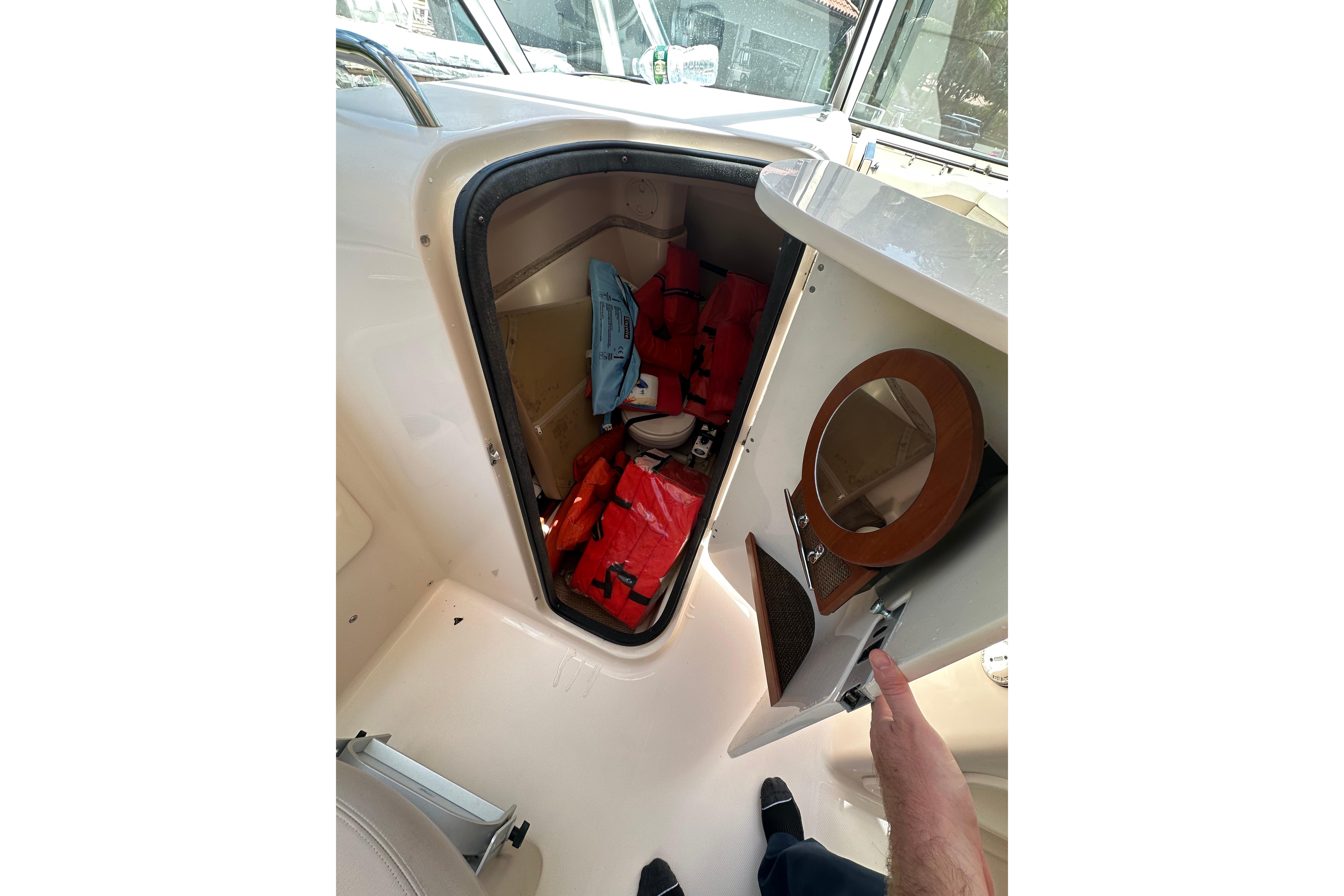 2014 Grady-White Freedom 275 boat storage with life jackets and safety gear.