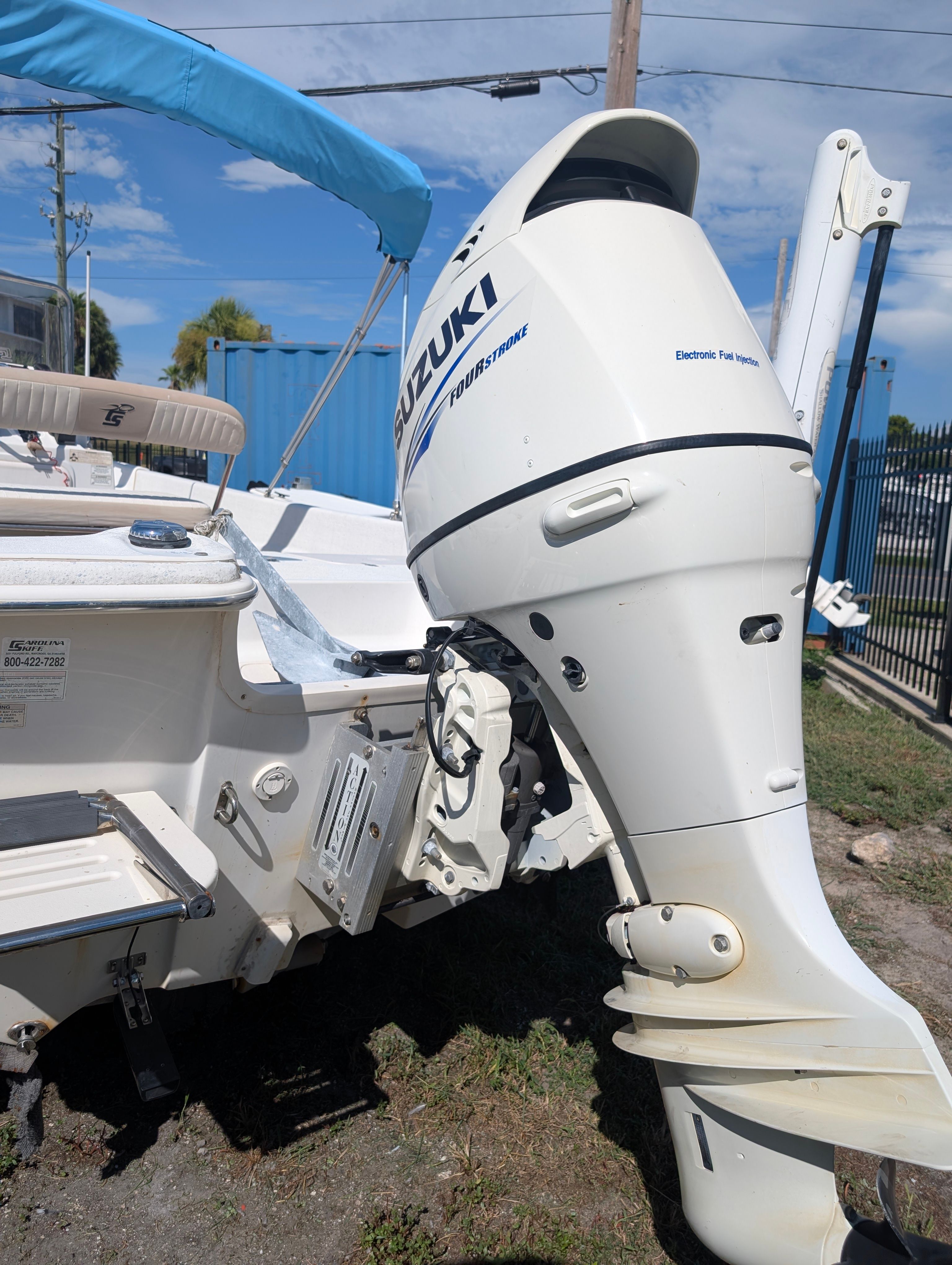 A Suzuki outboard motor is mounted on a Carolina Skiff 198 DLV boat.