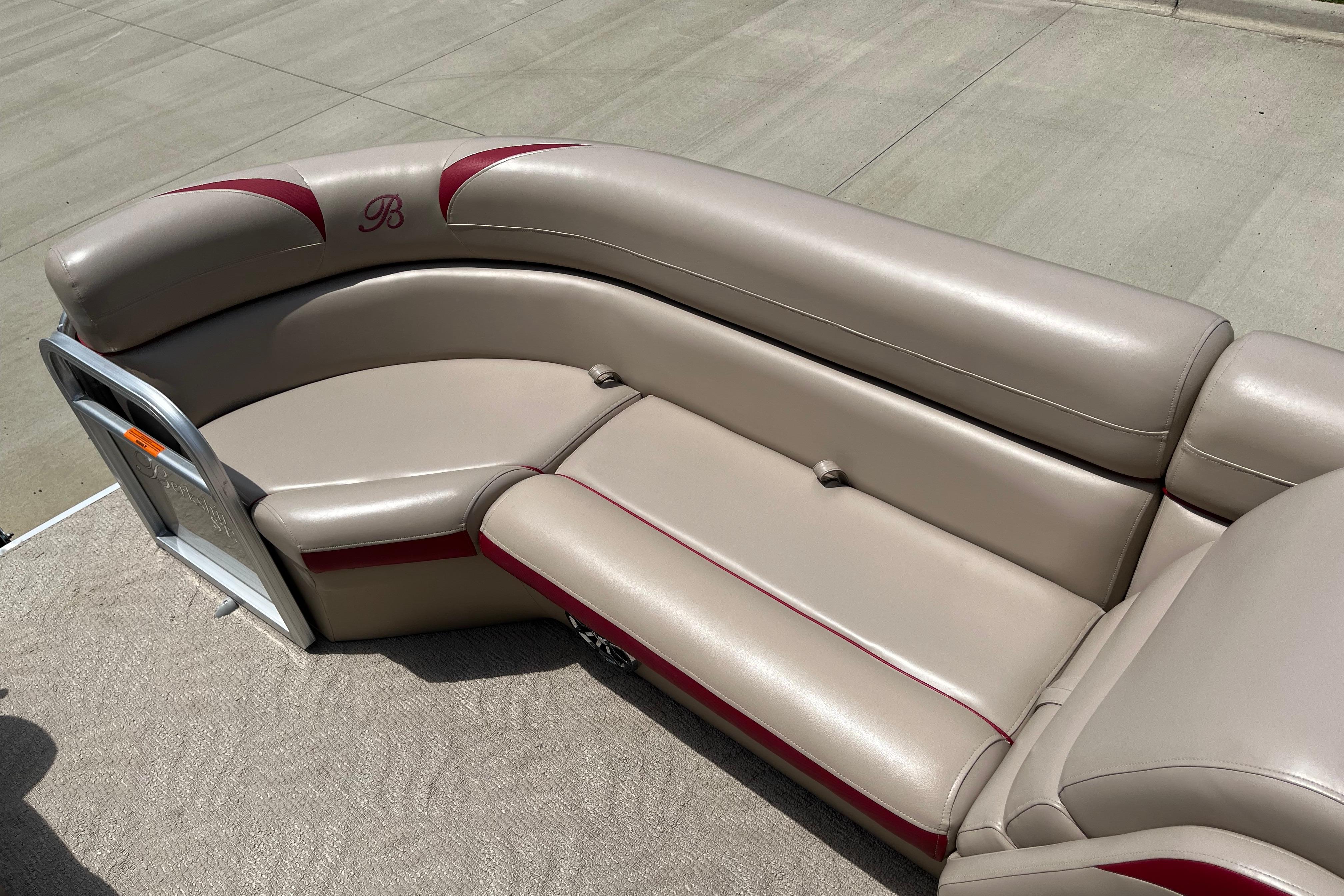 2013 Berkshire 230CL CTS boat seating with beige upholstery and red accents.
