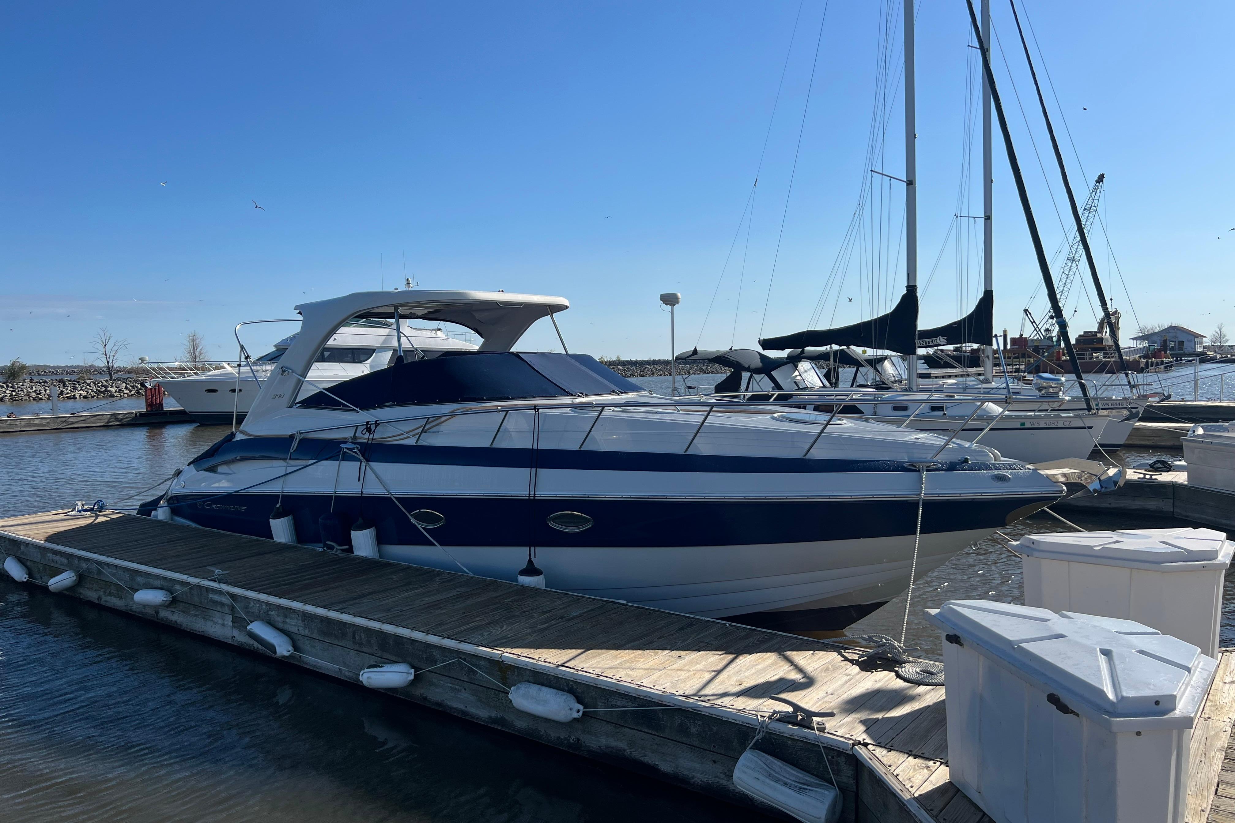 2008 Crownline 340 CR yacht docked at marina under clear blue sky.