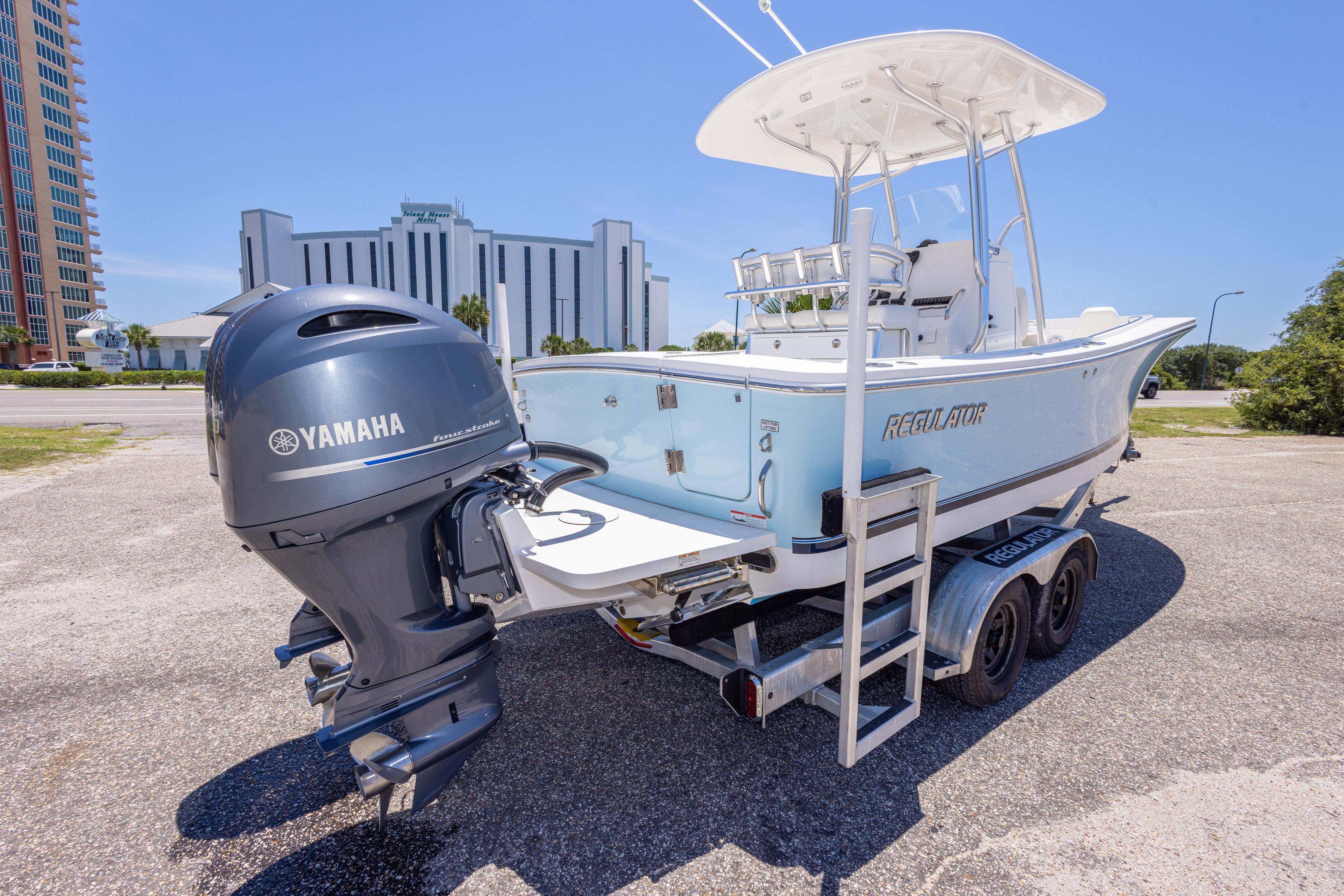 2019 Regulator 23 Center Console boat with Yamaha engine on trailer, parked outdoors.