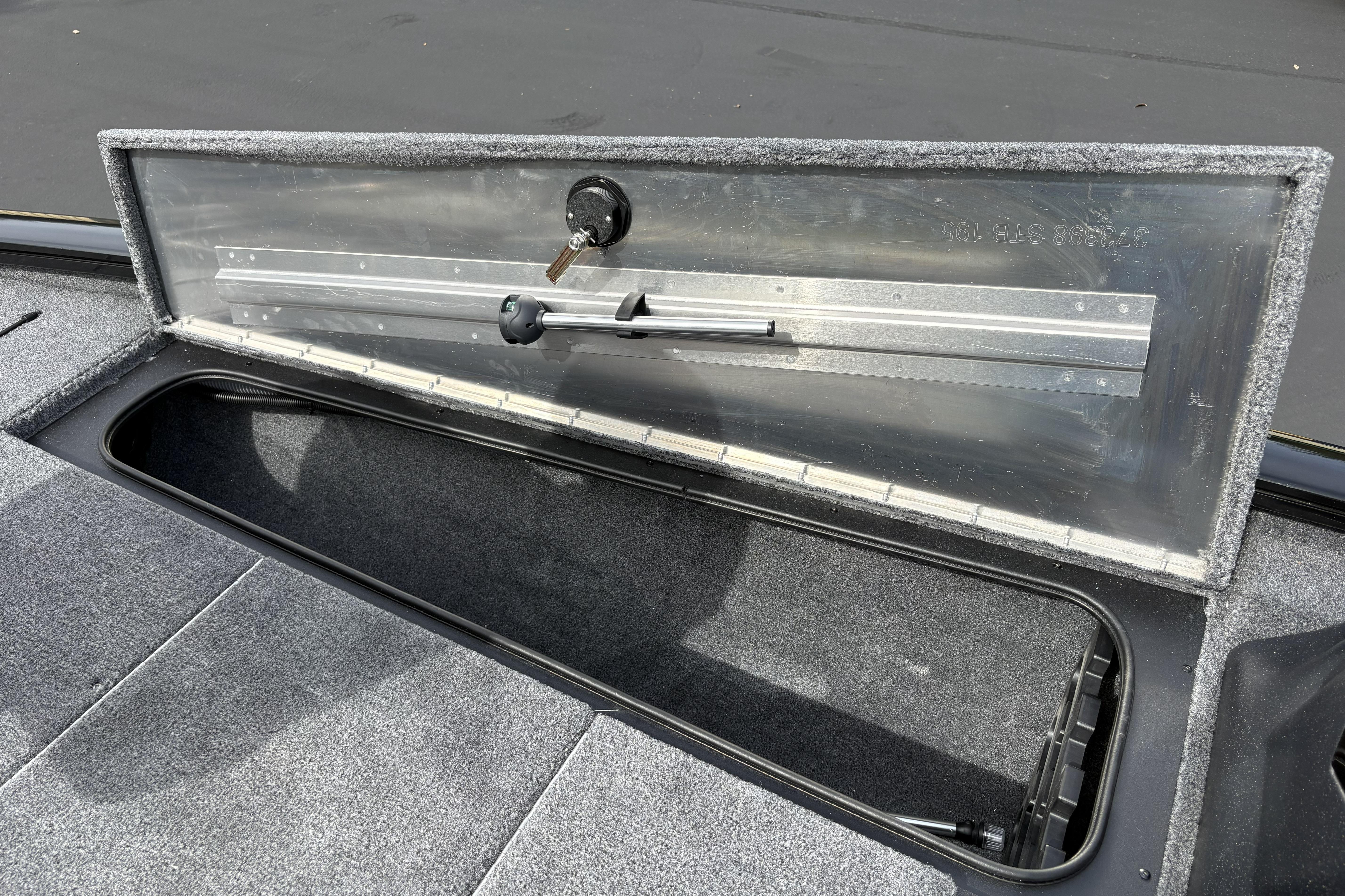 Open storage compartment in 2026 Tracker Pro Team 195 boat, featuring secure lock mechanism.