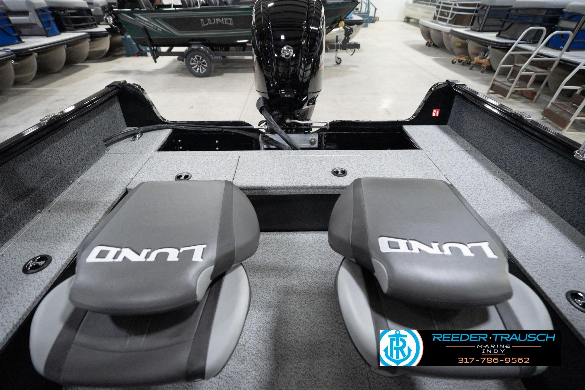 2026 Lund 1800 Explorer Sport boat interior with branded seats in a showroom.