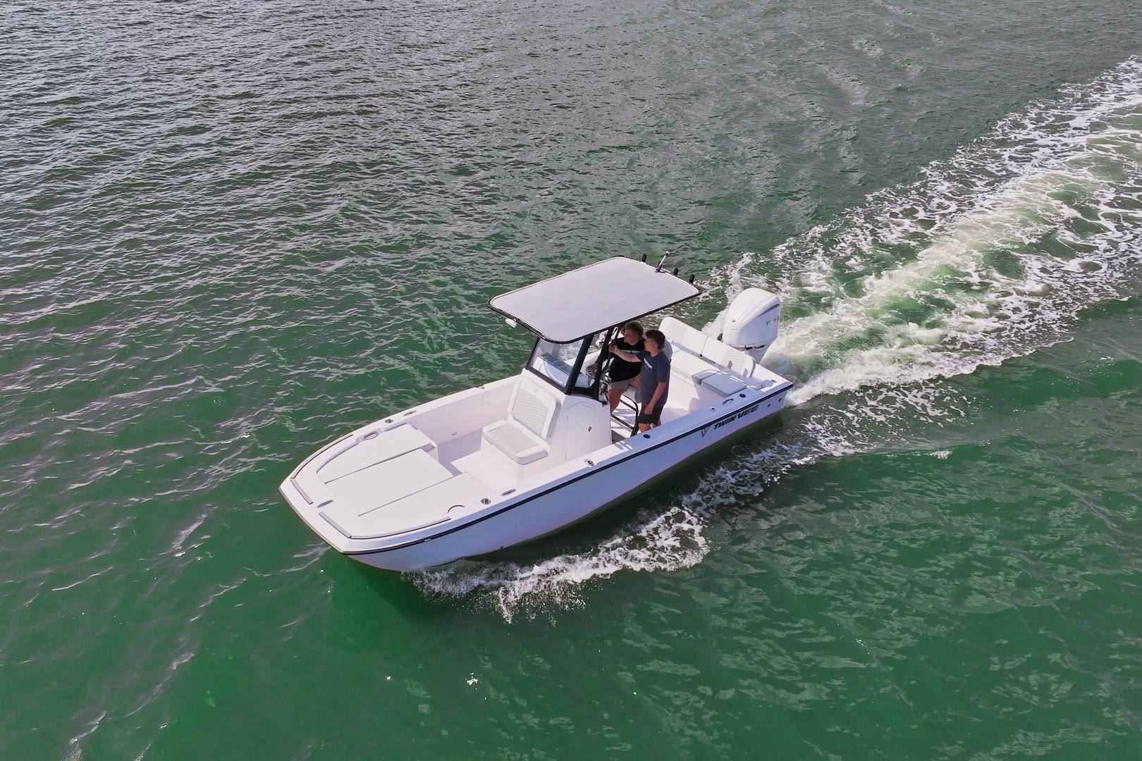 2026 Twin Vee 22 BayCat cruising on open water, showcasing sleek design and performance.