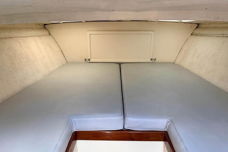 Interior cabin of a 1983 Cigarette 24' Classic boat with cushioned seating.