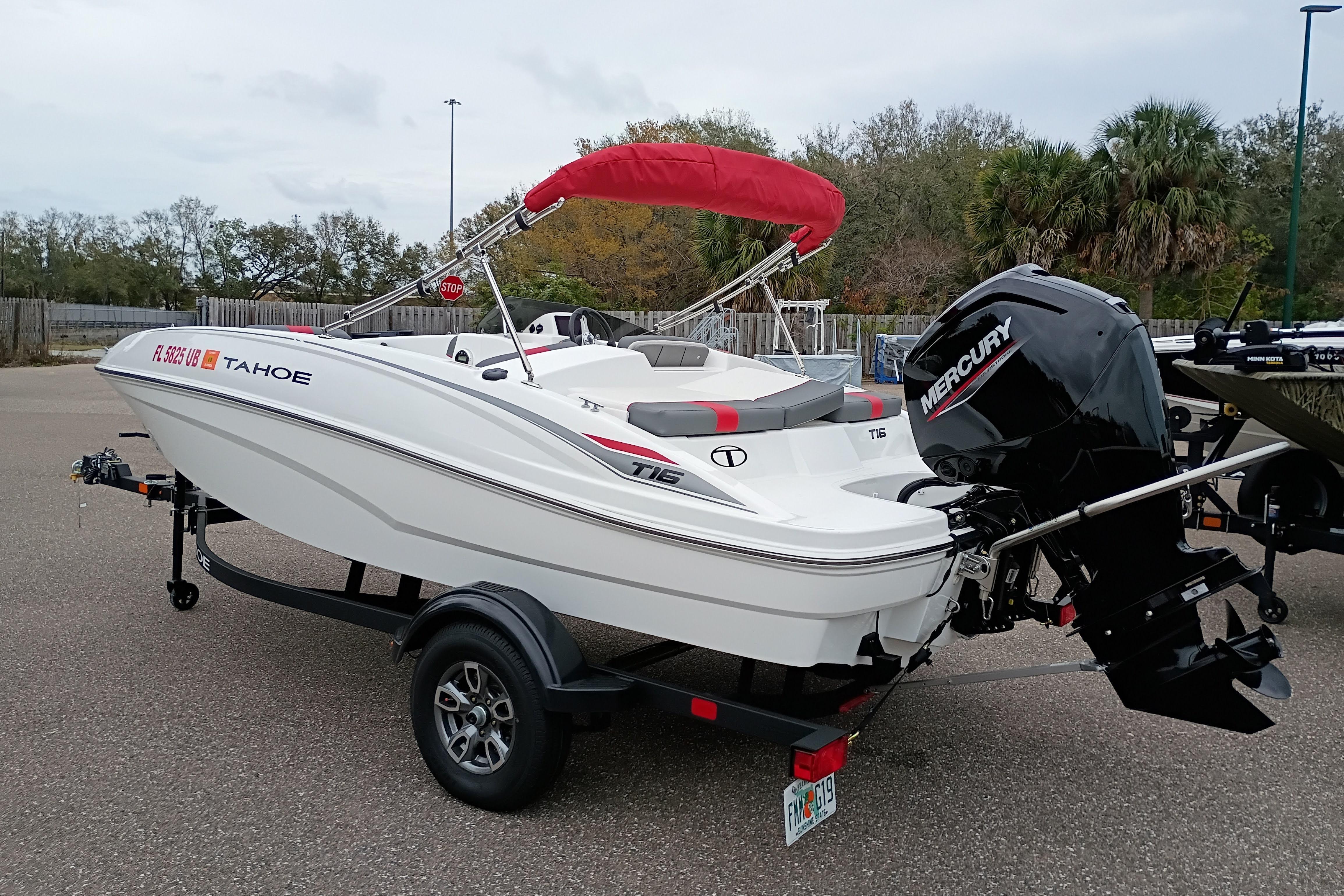 2026 Tahoe T16 boat with Mercury engine on trailer, featuring red canopy.