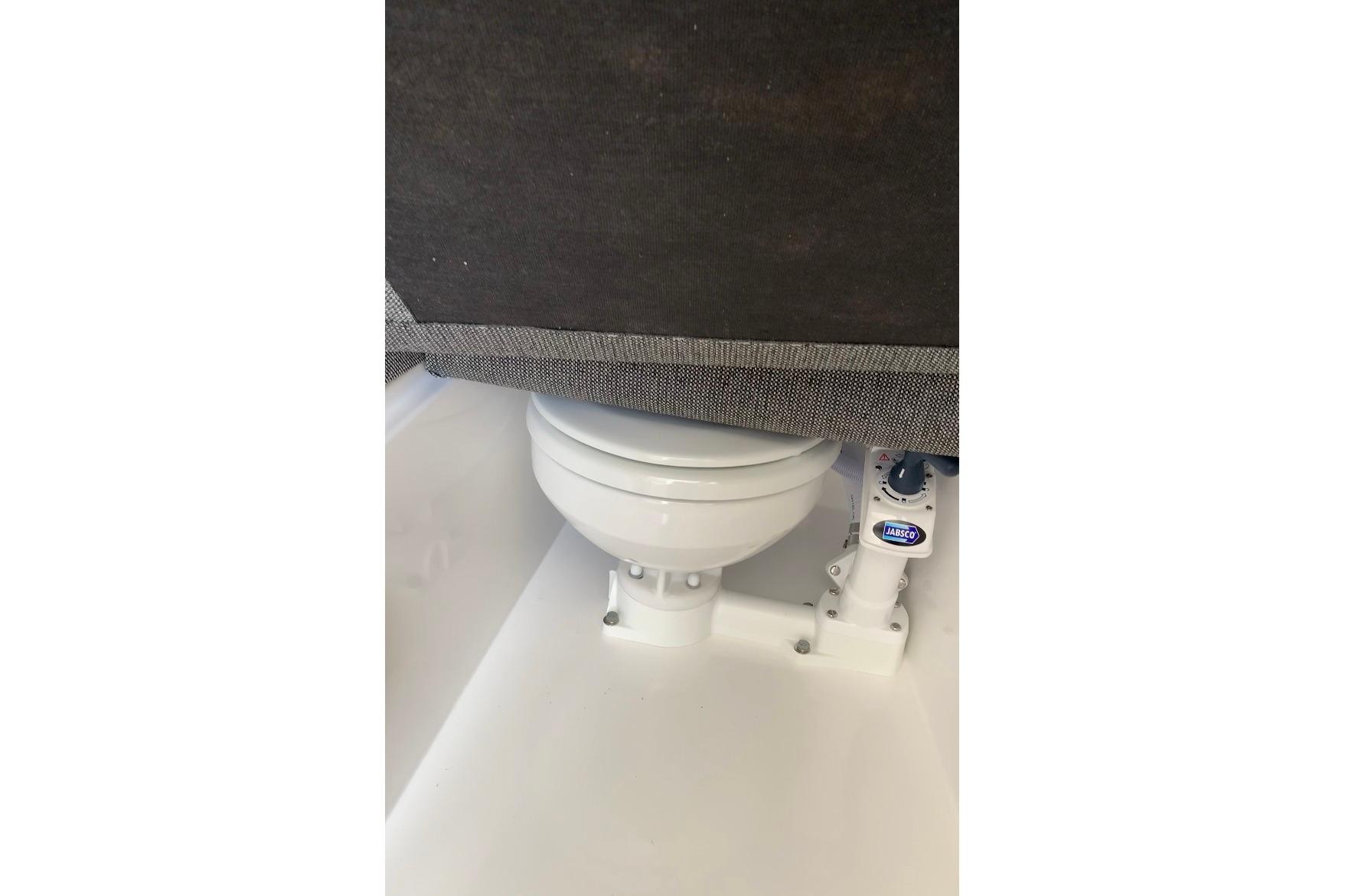 Marine toilet in 2026 Sea Sport Kenai 2600 boat, featuring Jabsco pump system.