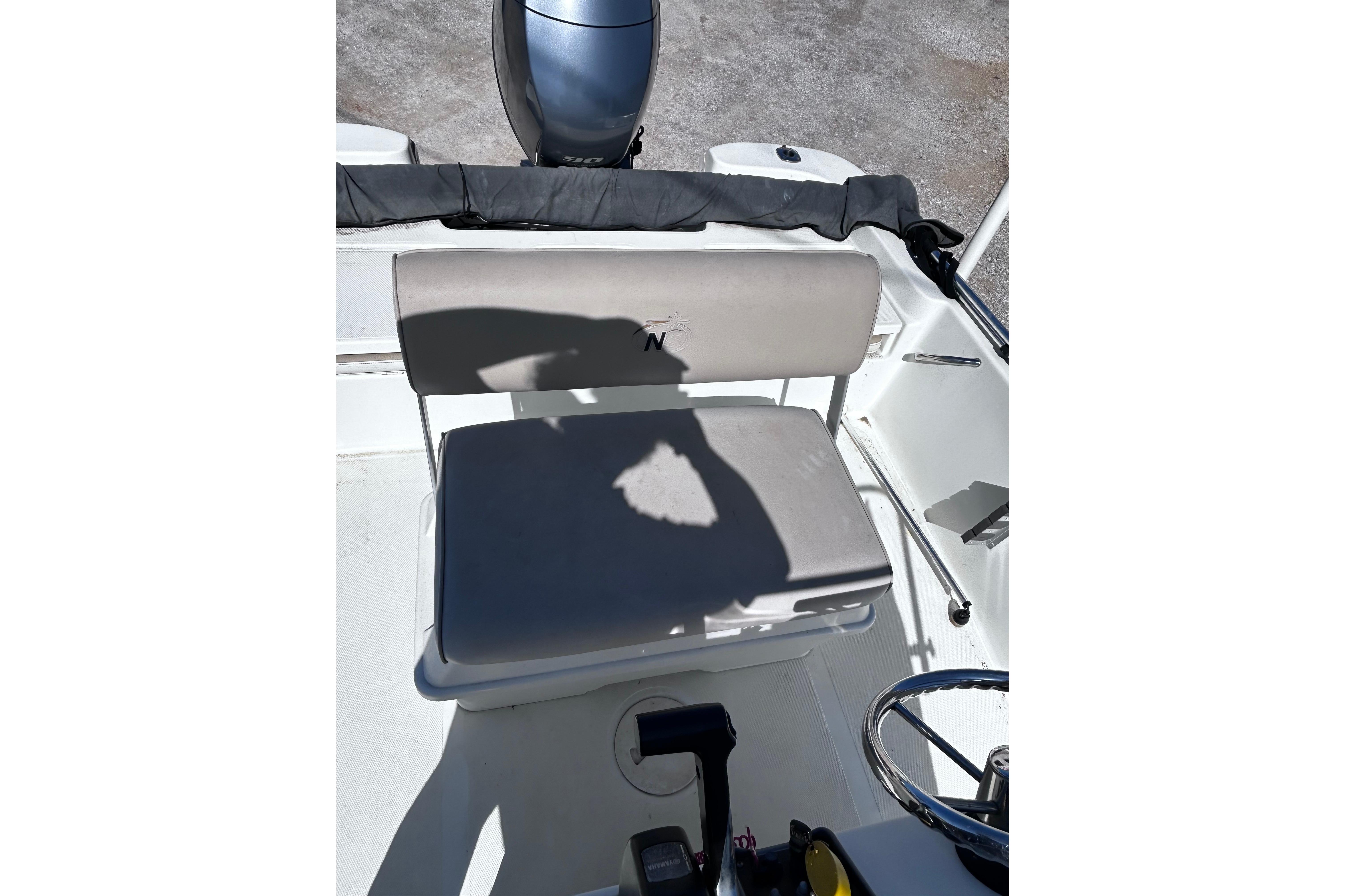 2016 NauticStar 1810 NauticBay boat interior with seating and steering wheel.