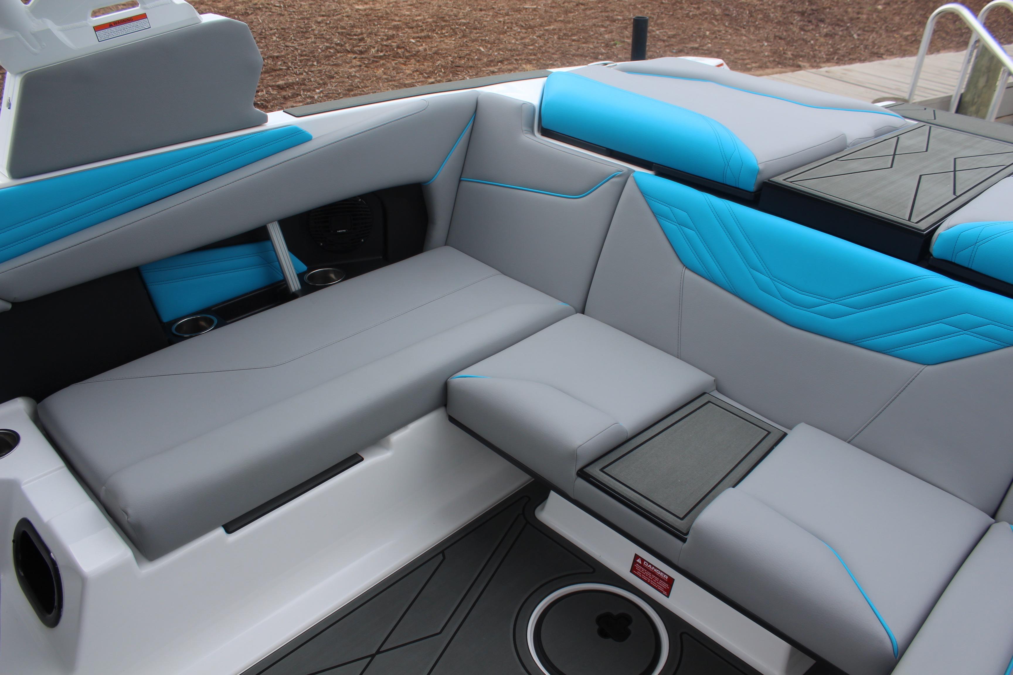 2026 ATX Surf Boats 22 Type-S interior with gray and blue seating, cup holders, and storage.
