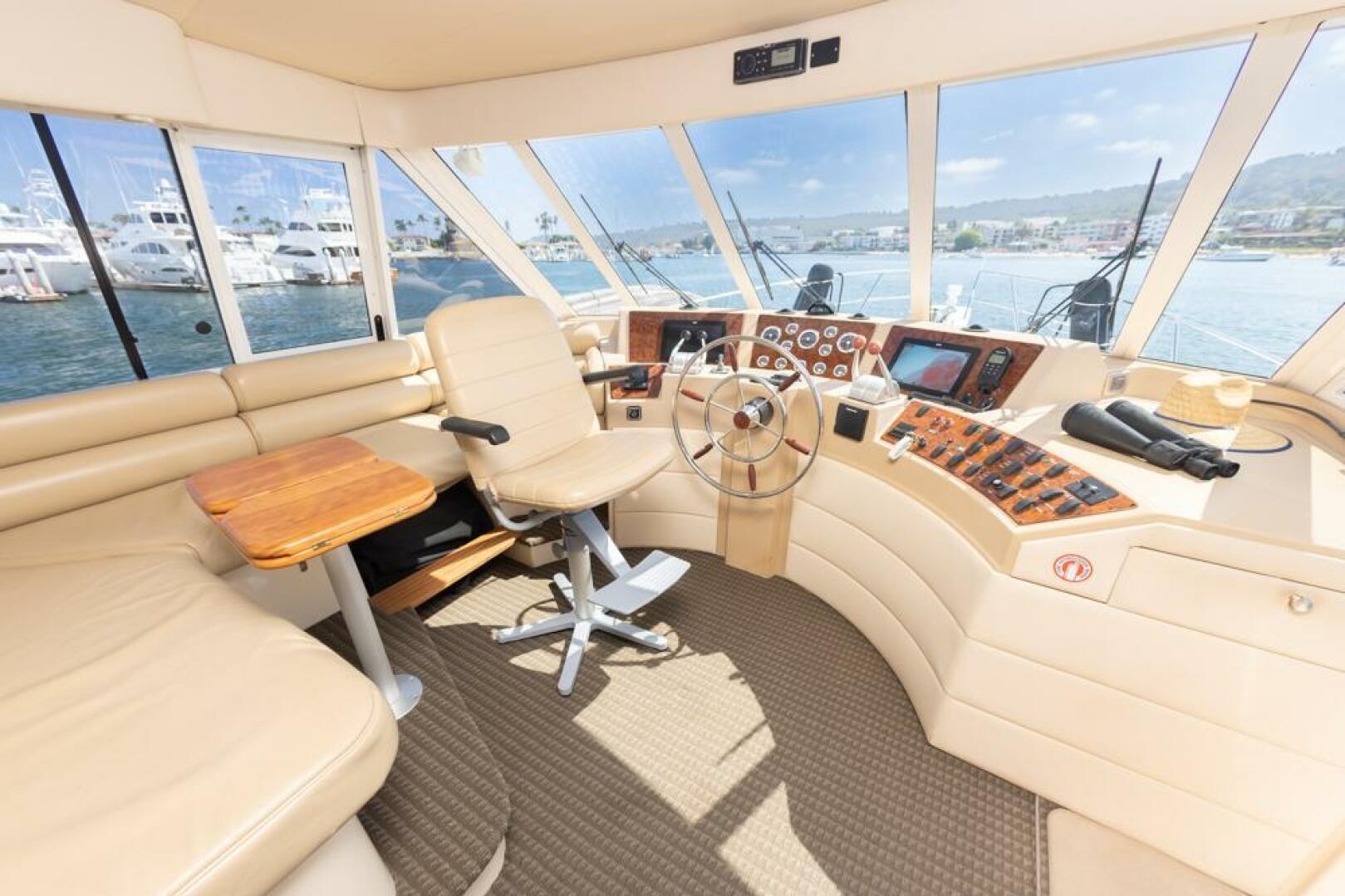 Luxurious 2004 Meridian 490 Pilothouse interior with helm, seating, and panoramic windows.
