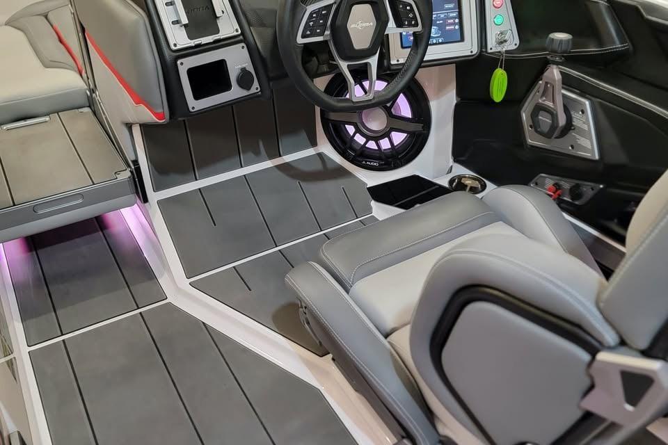 2023 Supra SE 550 boat interior with modern steering and dashboard controls.