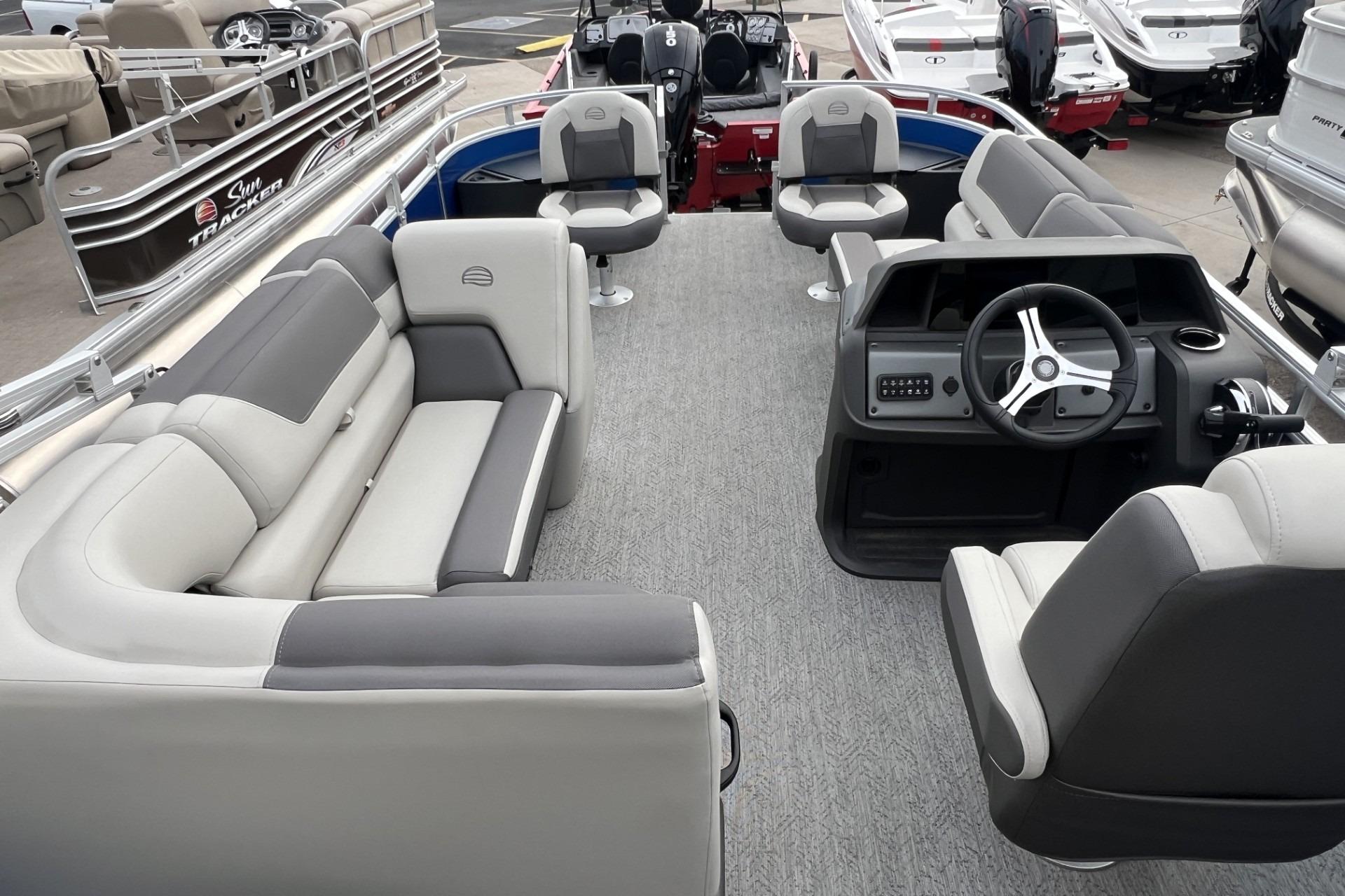2026 Sun Tracker Fishin' Barge 20 DLX interior with seating and steering console.