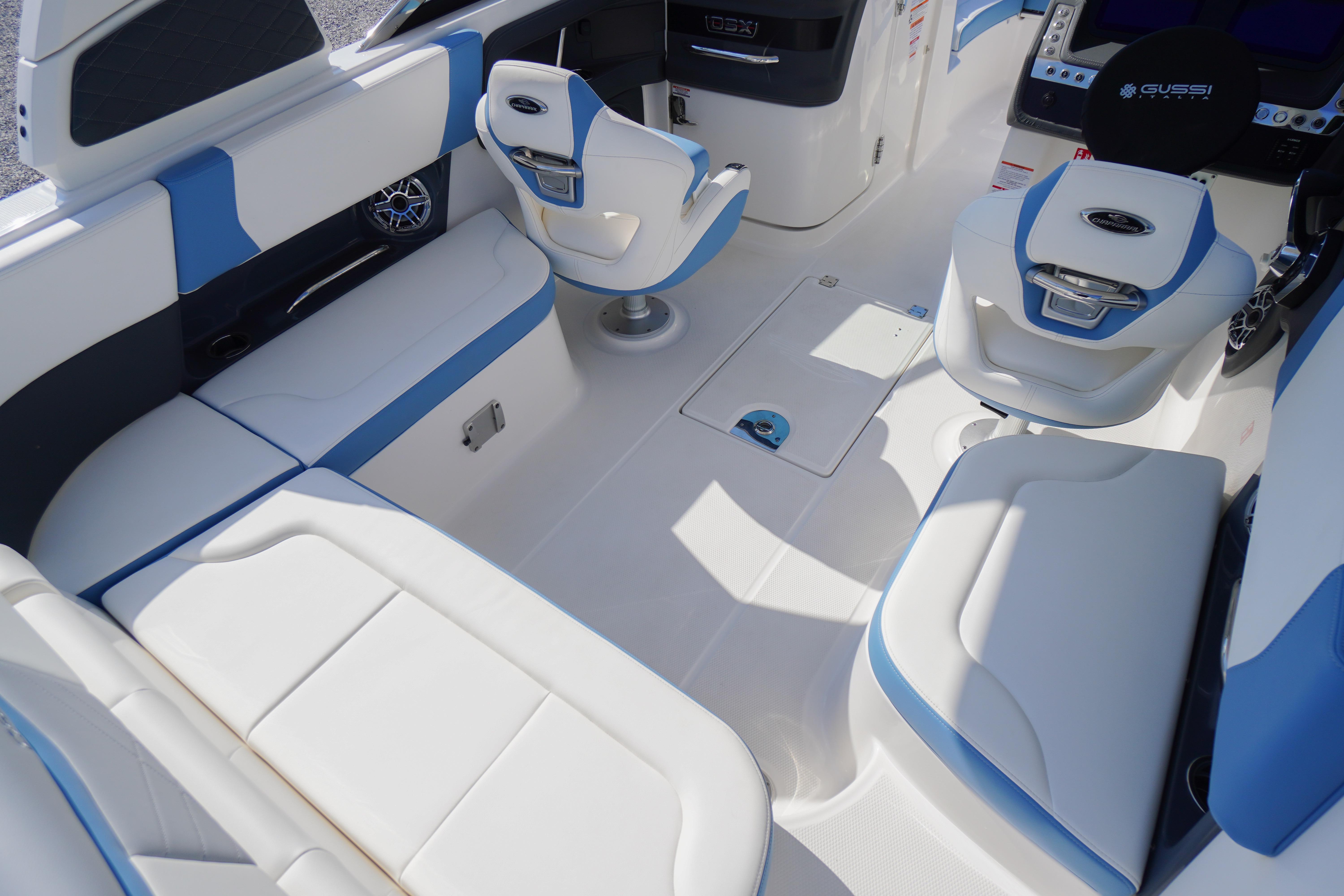 Interior of 2026 Chaparral 270 OSX boat with white and blue seating.