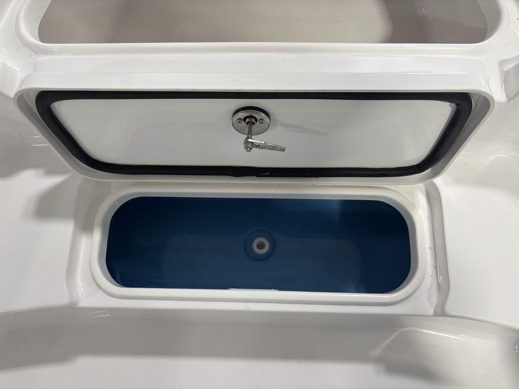 Open storage compartment on 2026 Tidewater 2110 BM boat, featuring a secure lock.