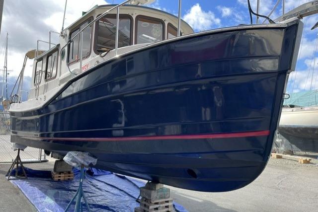 2008 Ranger 25 on stands, blue hull, marina background.