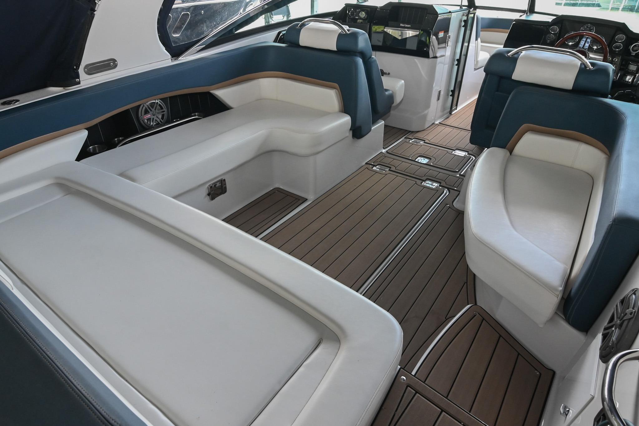 Luxurious interior of 2014 Four Winns H290 boat with elegant seating and wood flooring.