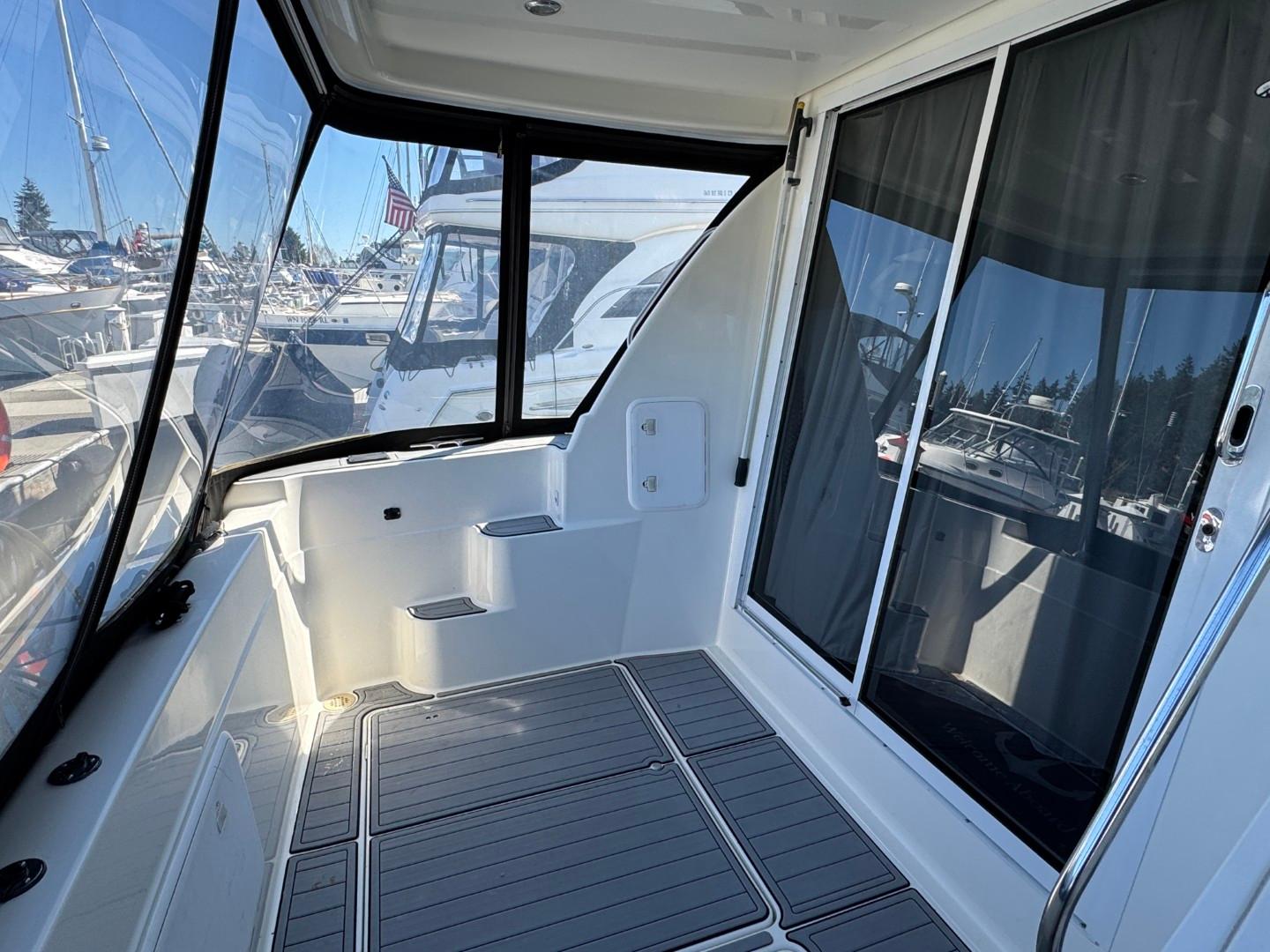 2003 Meridian 381 Sedan yacht interior with sliding glass doors and marina view.
