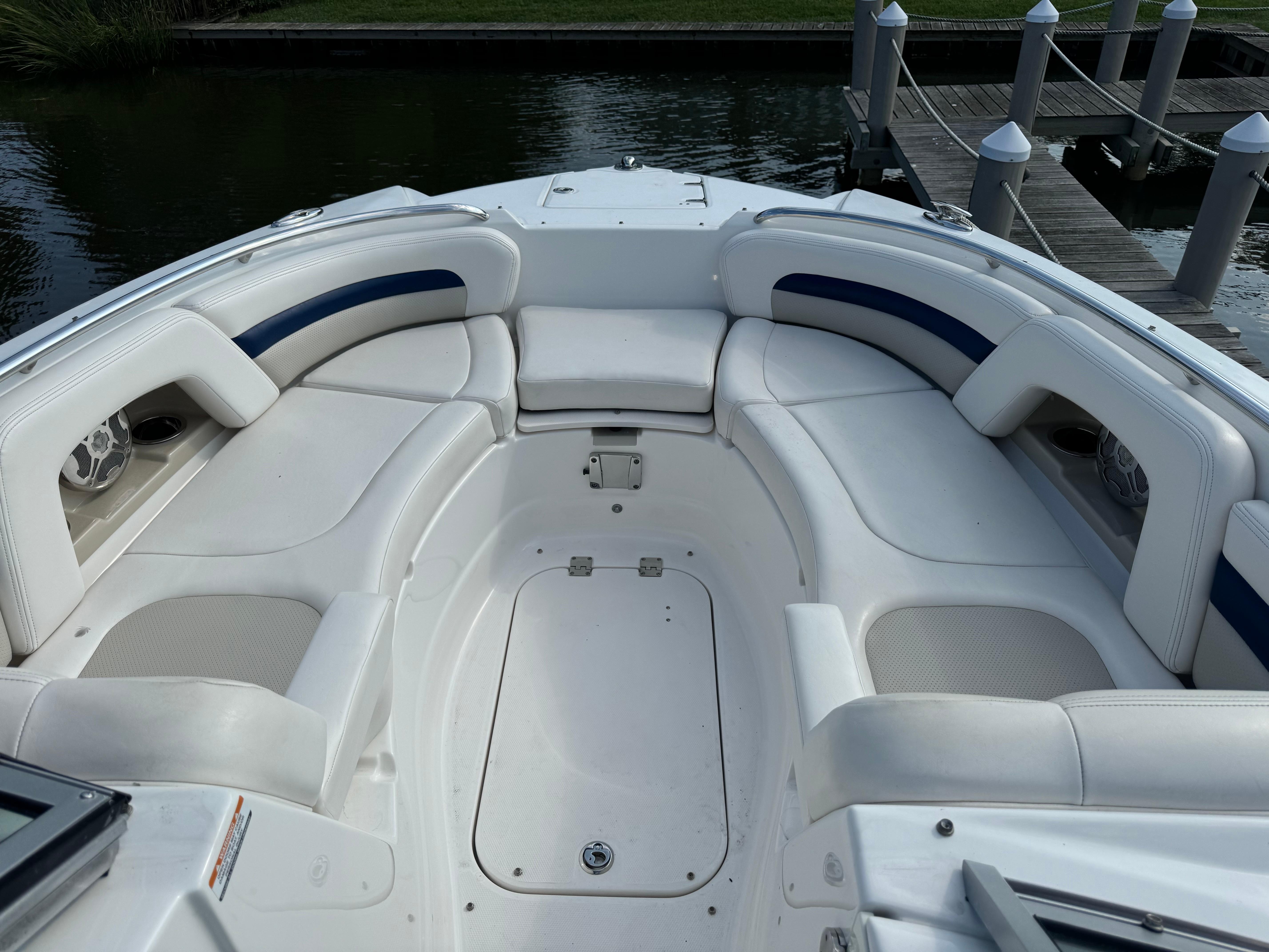 2012 Chaparral 264 Sunesta boat with spacious seating at the dock.