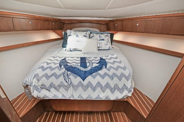 Luxurious cabin interior of 2008 Tiara Yachts 4200 Open with nautical-themed bedding.