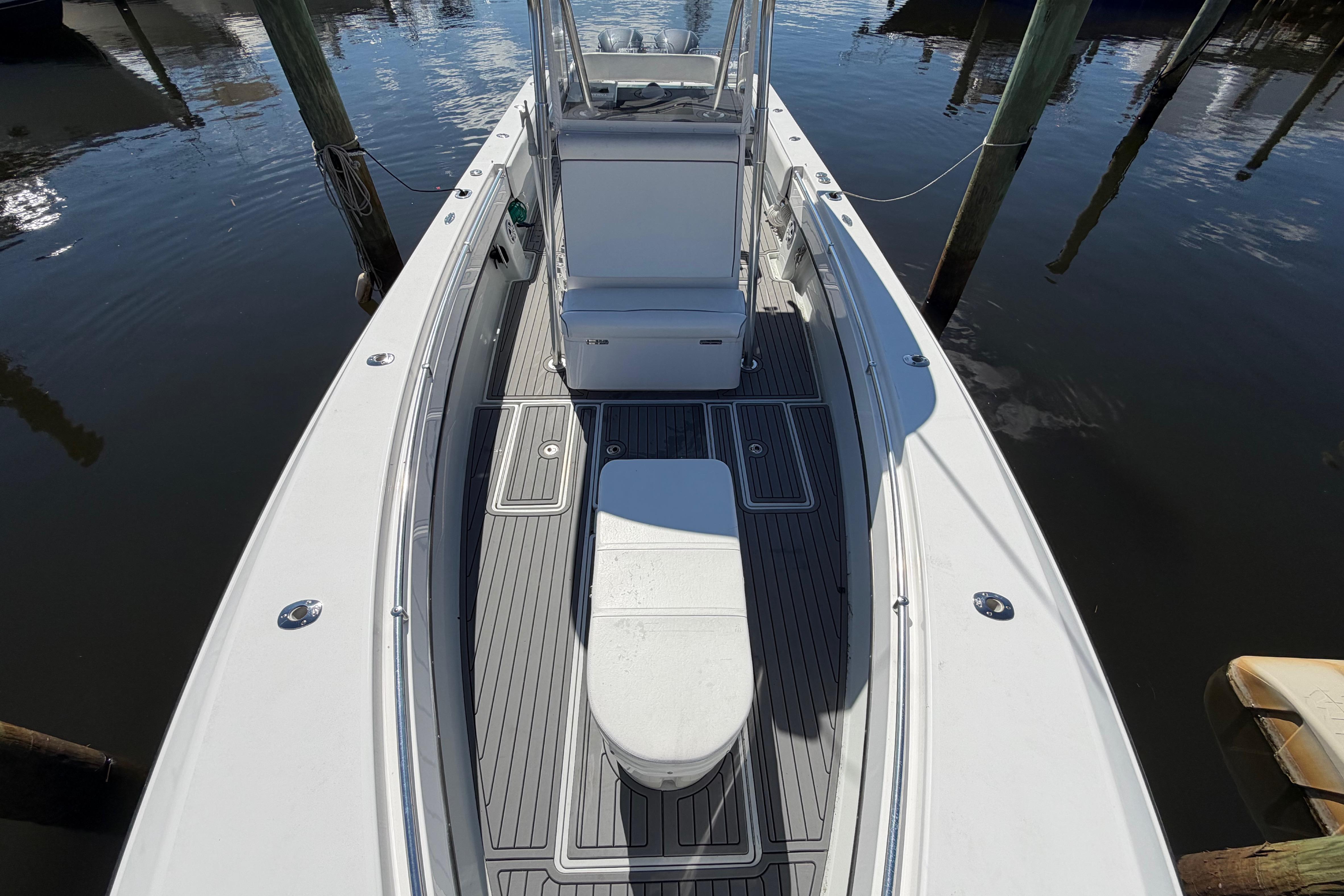 2015 Contender 32 ST boat docked, showcasing spacious deck and seating area.