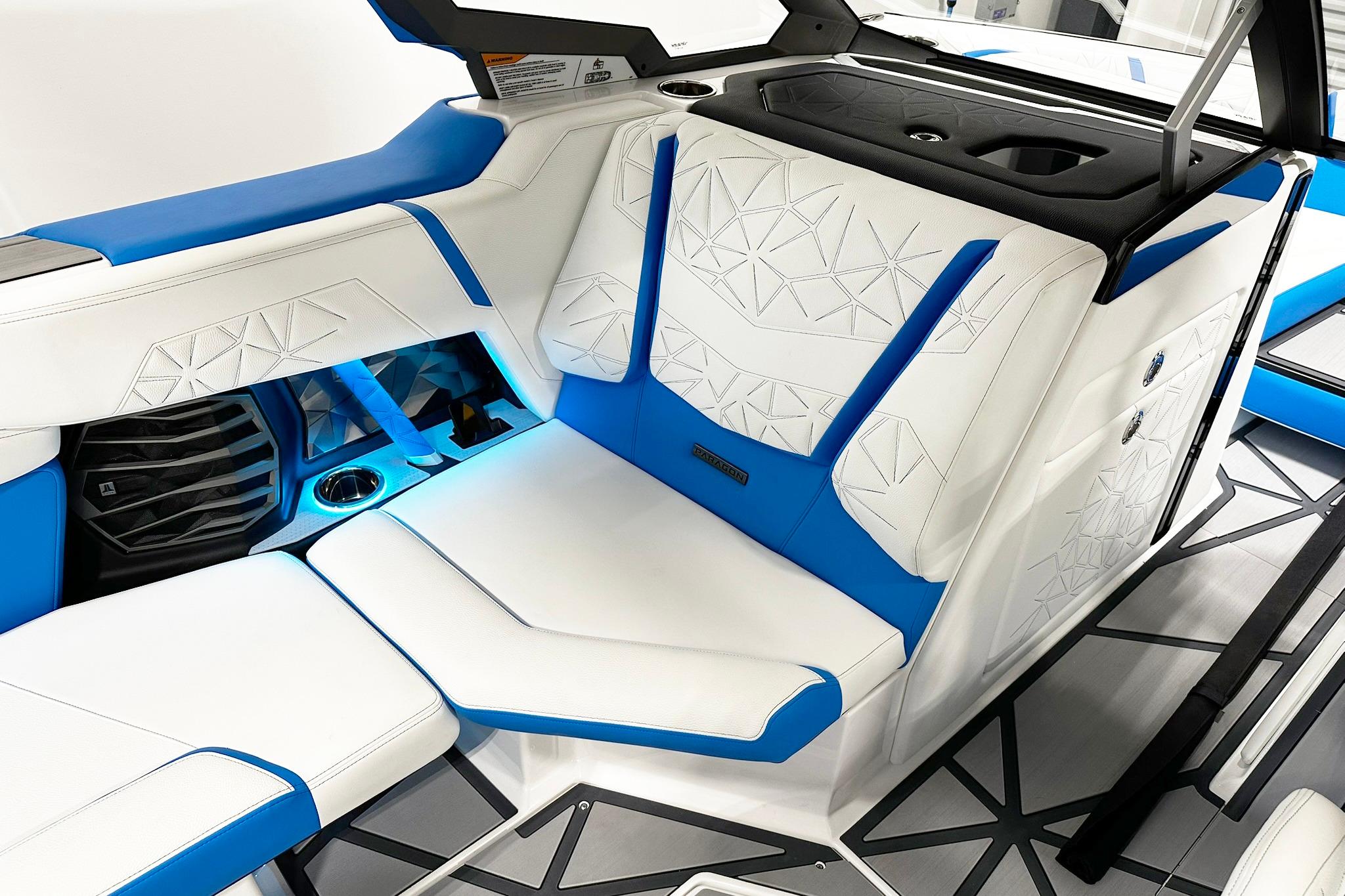 2025 Nautique Super Air Nautique G23 Paragon interior with white and blue luxury seating.