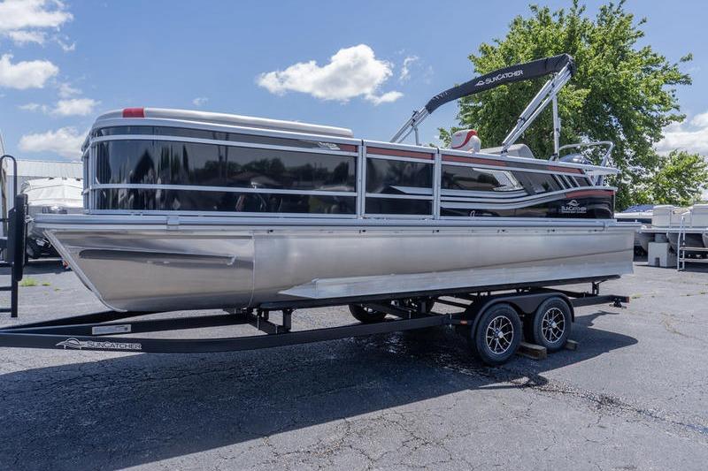 2026 SunCatcher Select 322SL pontoon boat on trailer, parked outdoors under a clear sky.